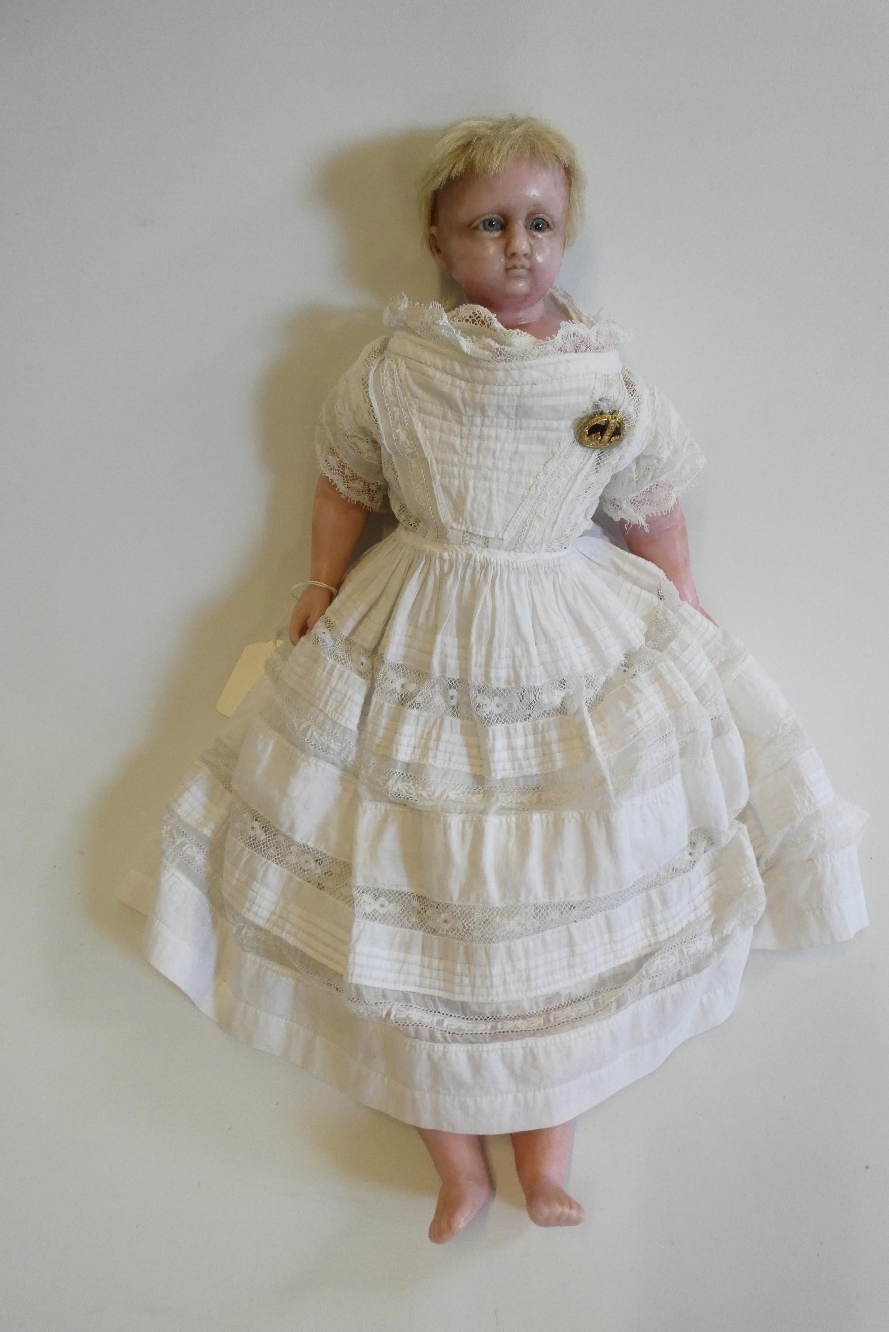 A Victorian wax shoulder head doll, with blue glass paperweight eyes, closed mouth, inserted blond Image