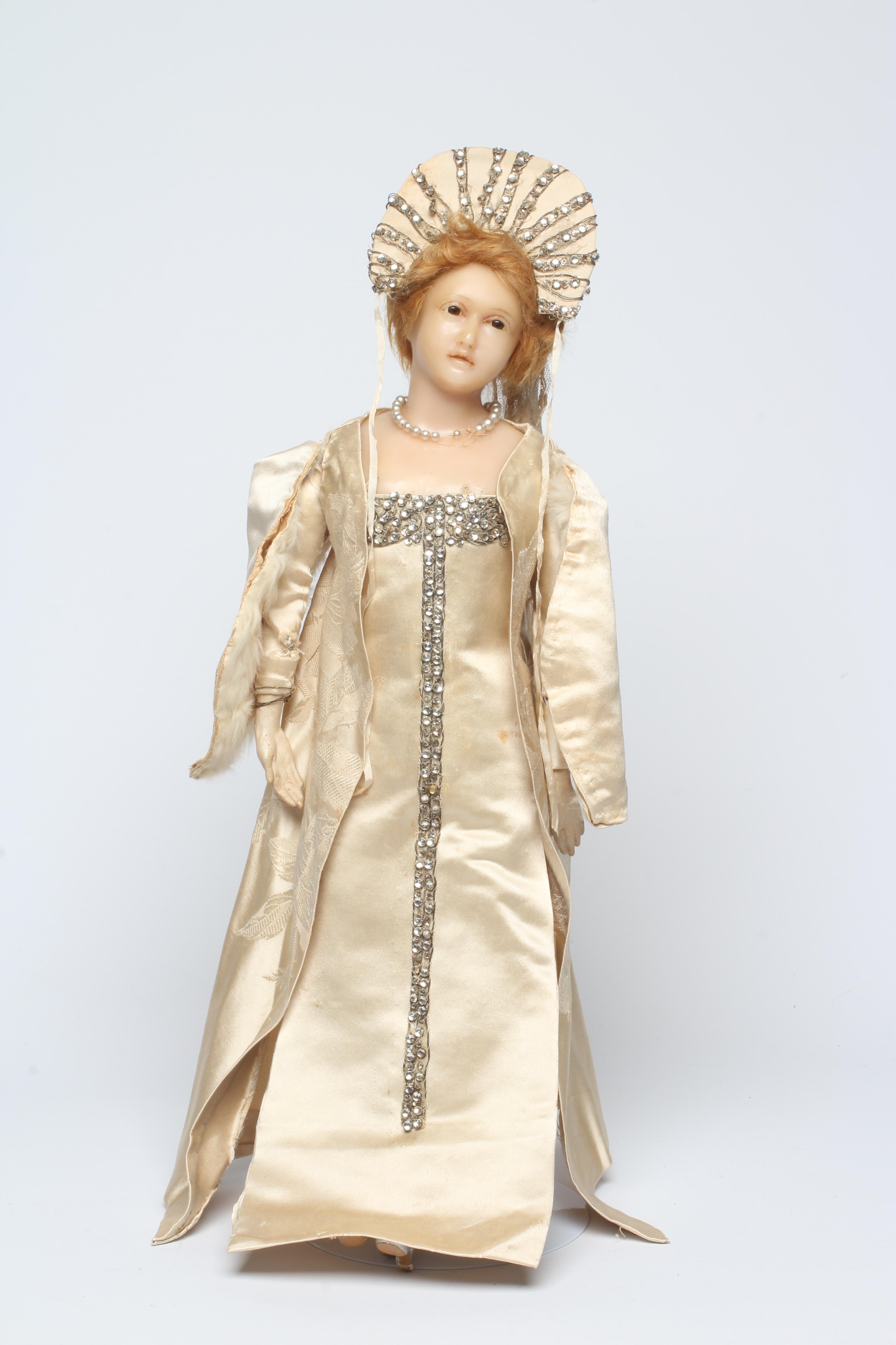 A high quality Victorian wax shoulder head doll with brown glass fixed eyes Image
