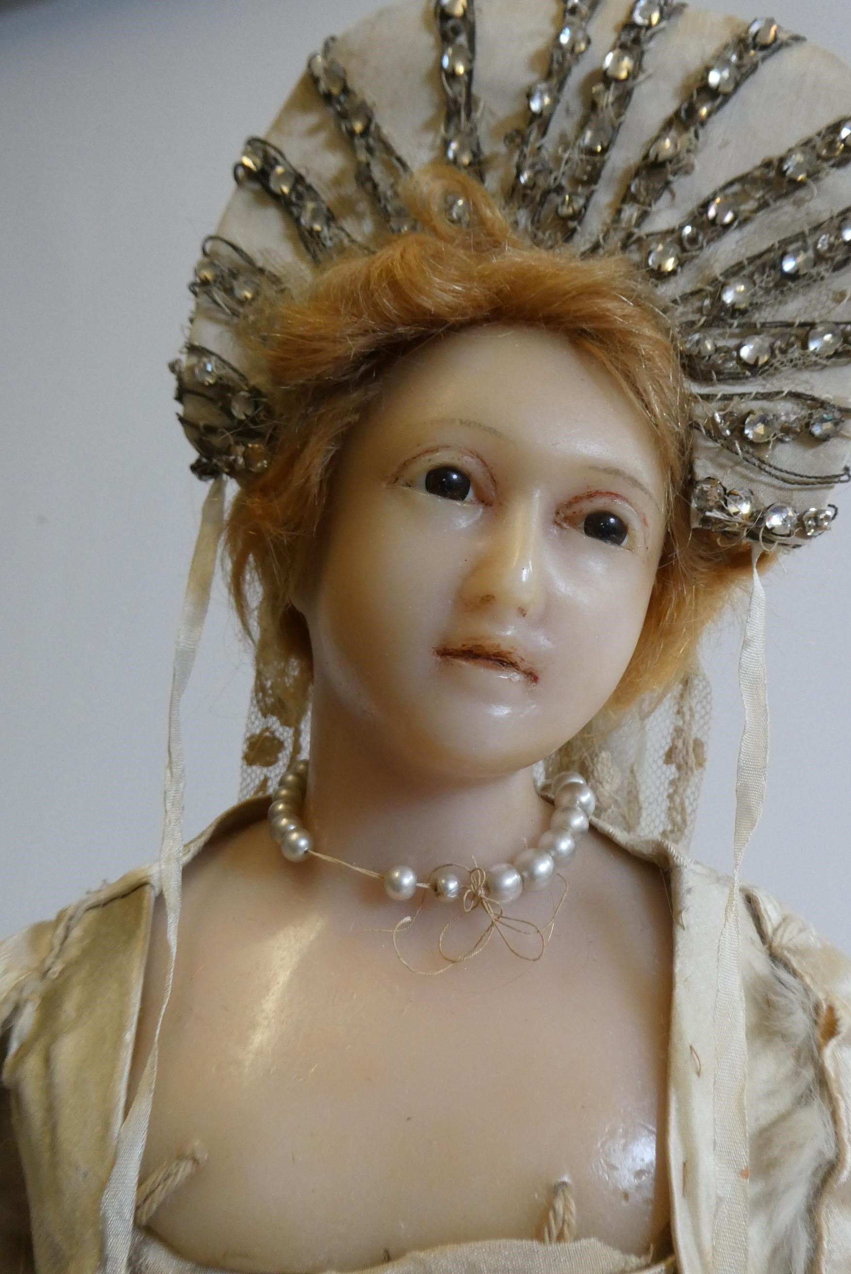 A high quality Victorian wax shoulder head doll with brown glass fixed eyes Image