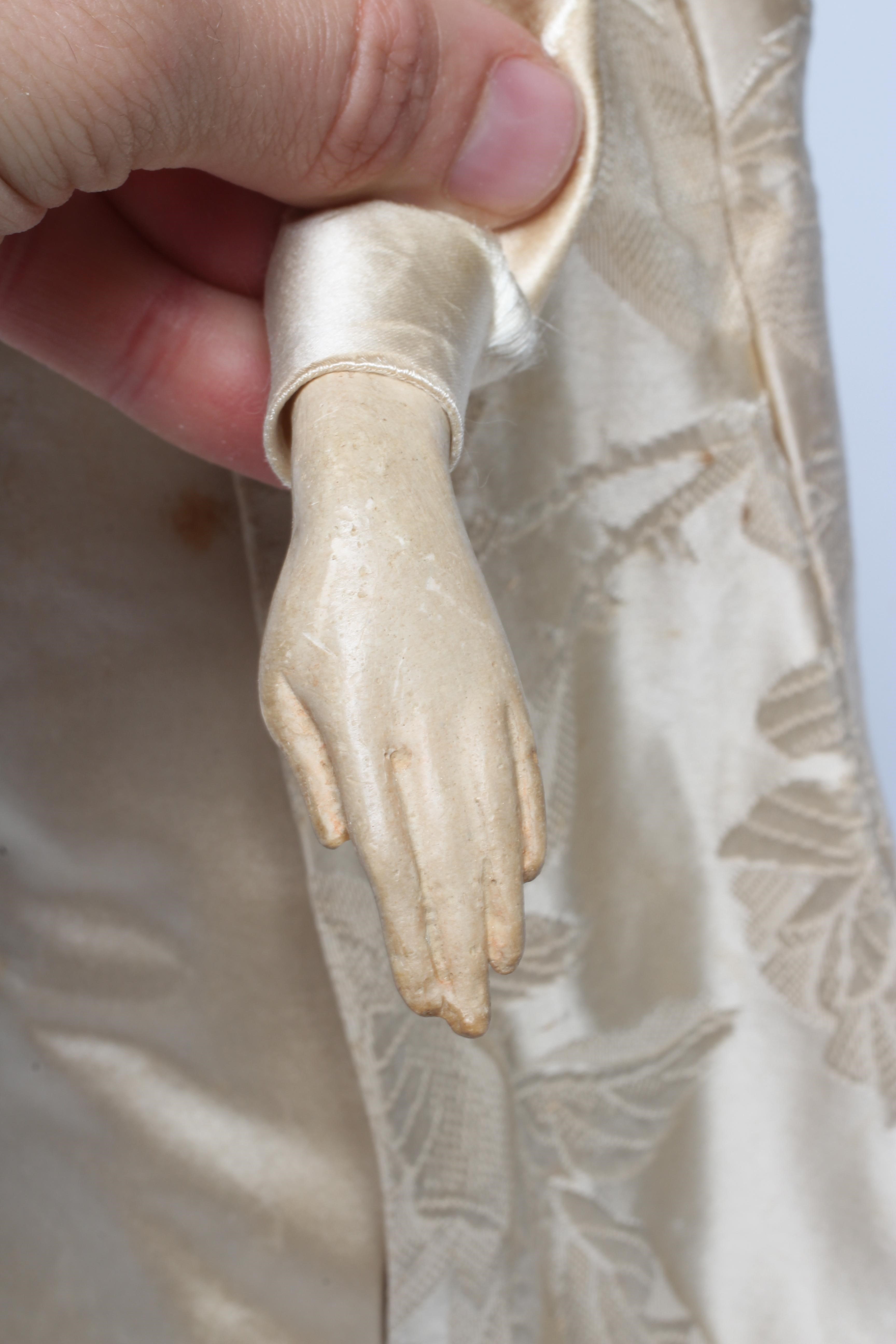 A high quality Victorian wax shoulder head doll with brown glass fixed eyes Image