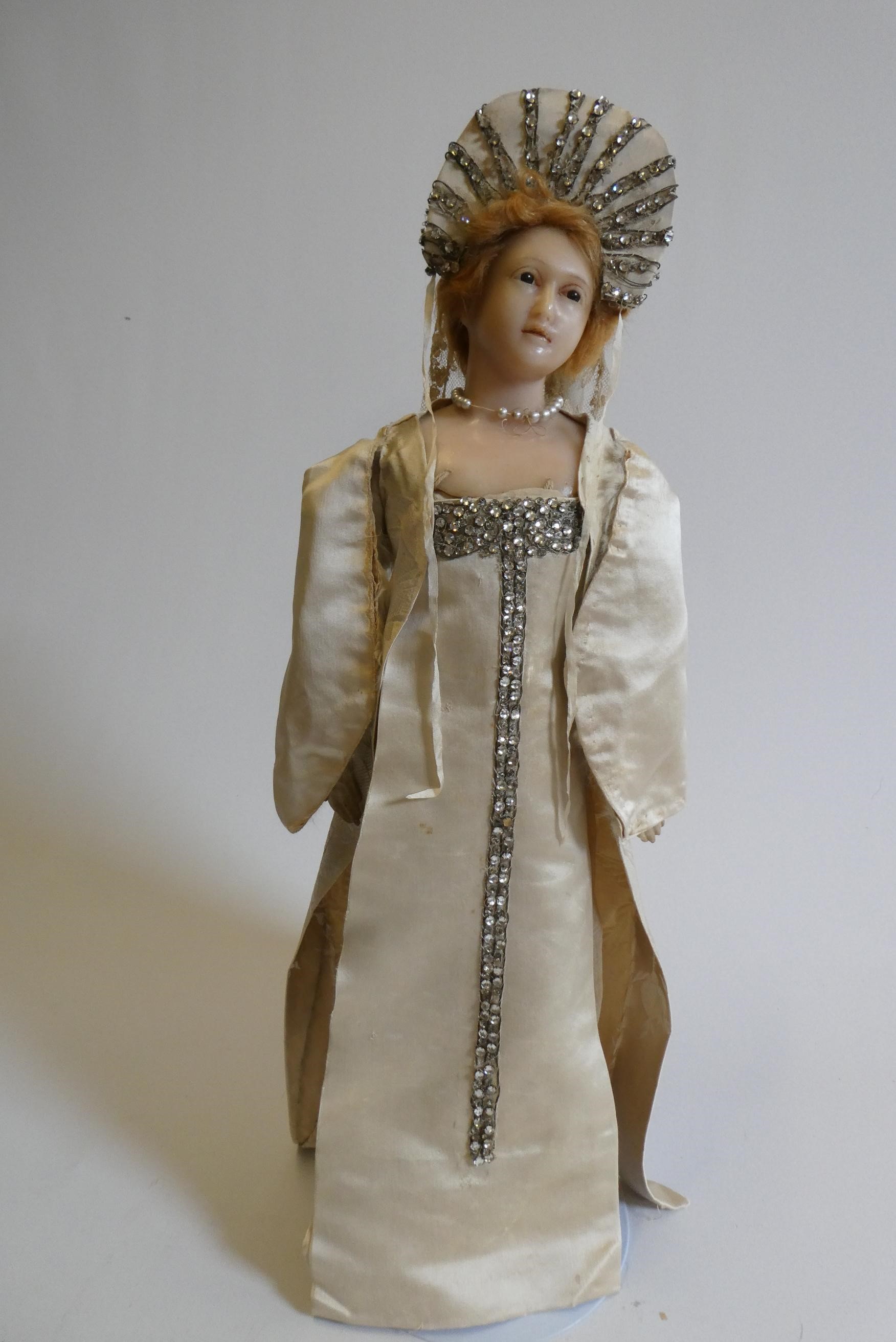 A high quality Victorian wax shoulder head doll with brown glass fixed eyes Image