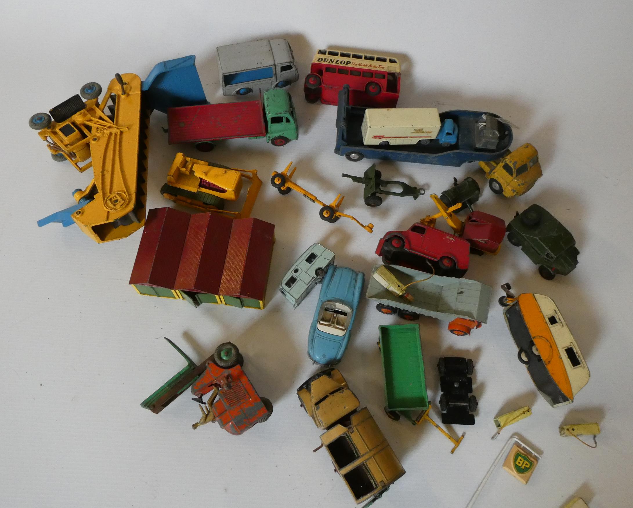 Unboxed playworn diecast vehicles by Dinky, Matchbox and others including bulldozer, elevator loader Image