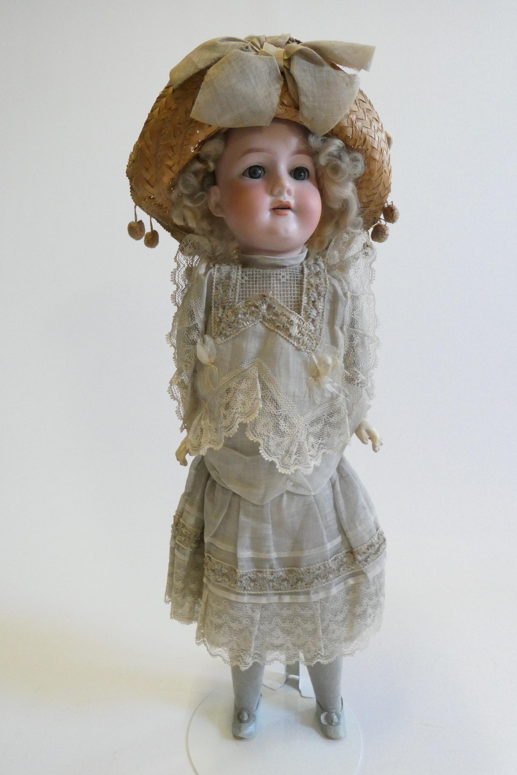 An Armand Marseille bisque socket head doll with blue glass sleeping eyes Image