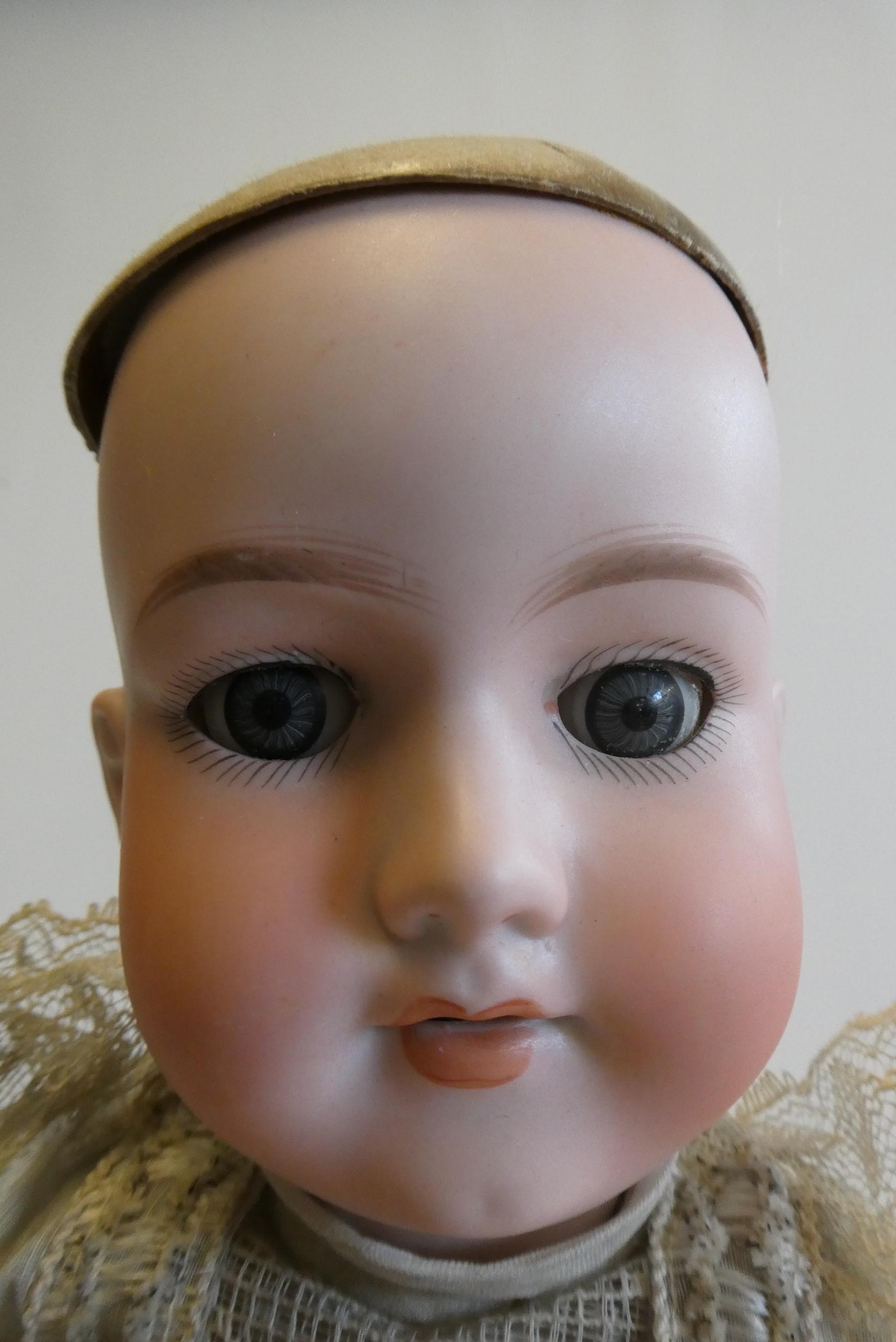 An Armand Marseille bisque socket head doll with blue glass sleeping eyes Image