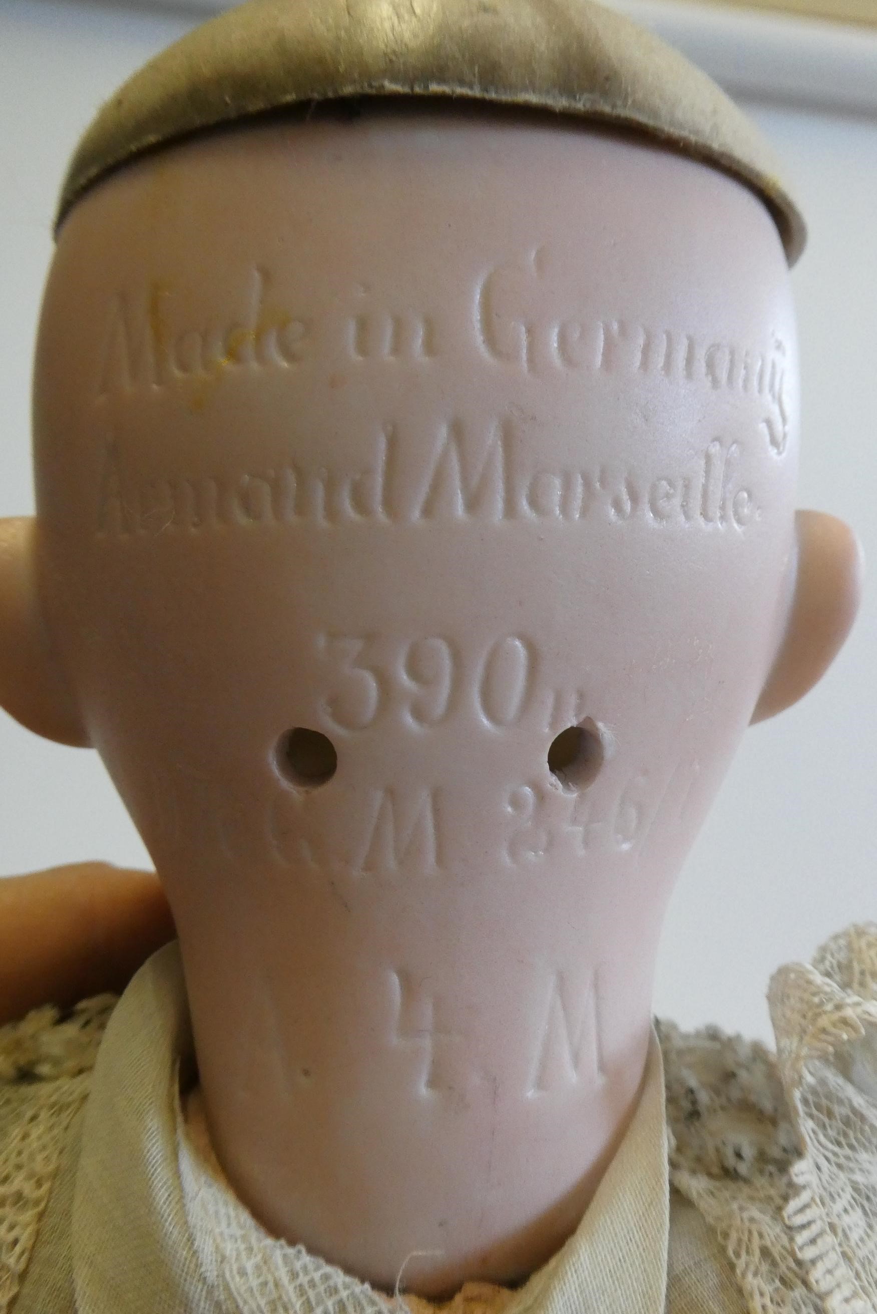 An Armand Marseille bisque socket head doll with blue glass sleeping eyes Image