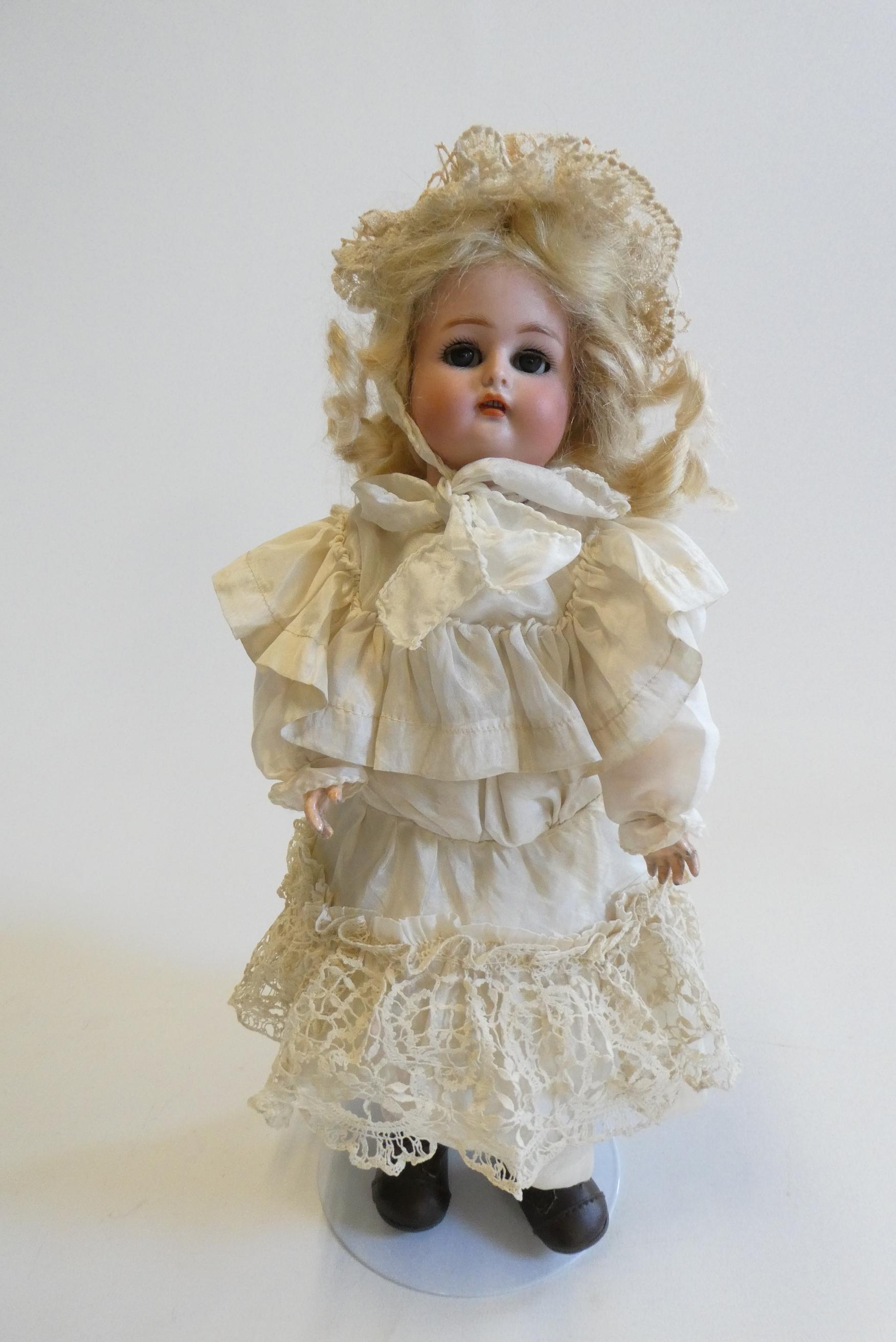 A Kammer & Reinhardt bisque socket head doll with blue glass sleeping eyes Image