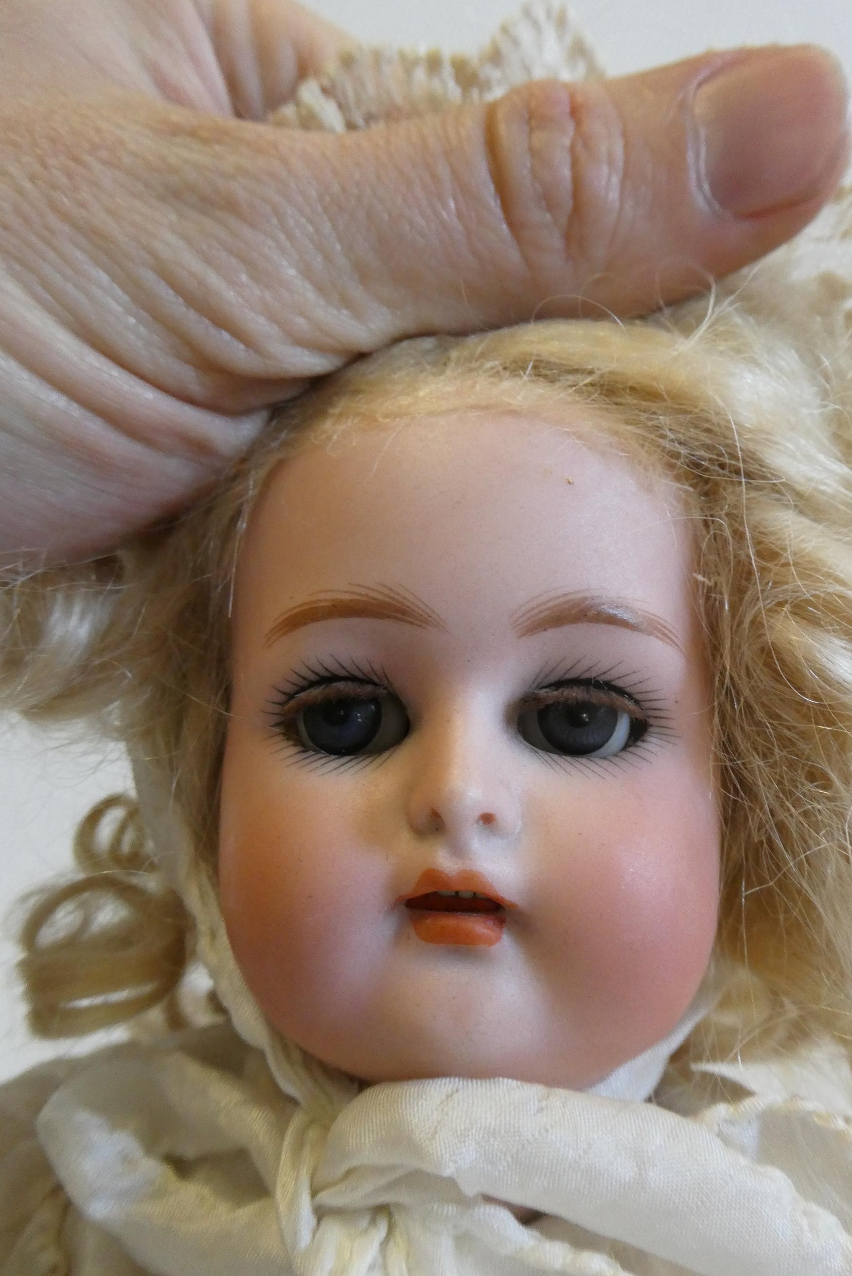 A Kammer & Reinhardt bisque socket head doll with blue glass sleeping eyes Image