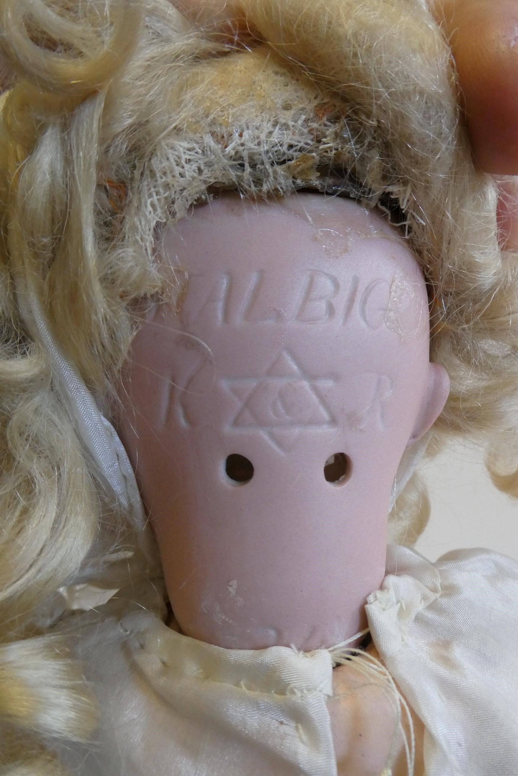 A Kammer & Reinhardt bisque socket head doll with blue glass sleeping eyes Image