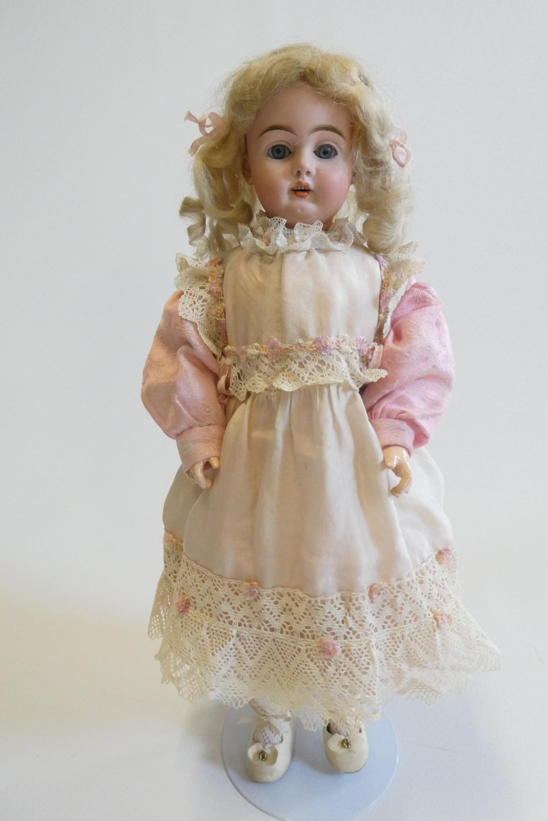 A Bahr & Proschild bisque socket head doll with blue glass sleeping eyes Image