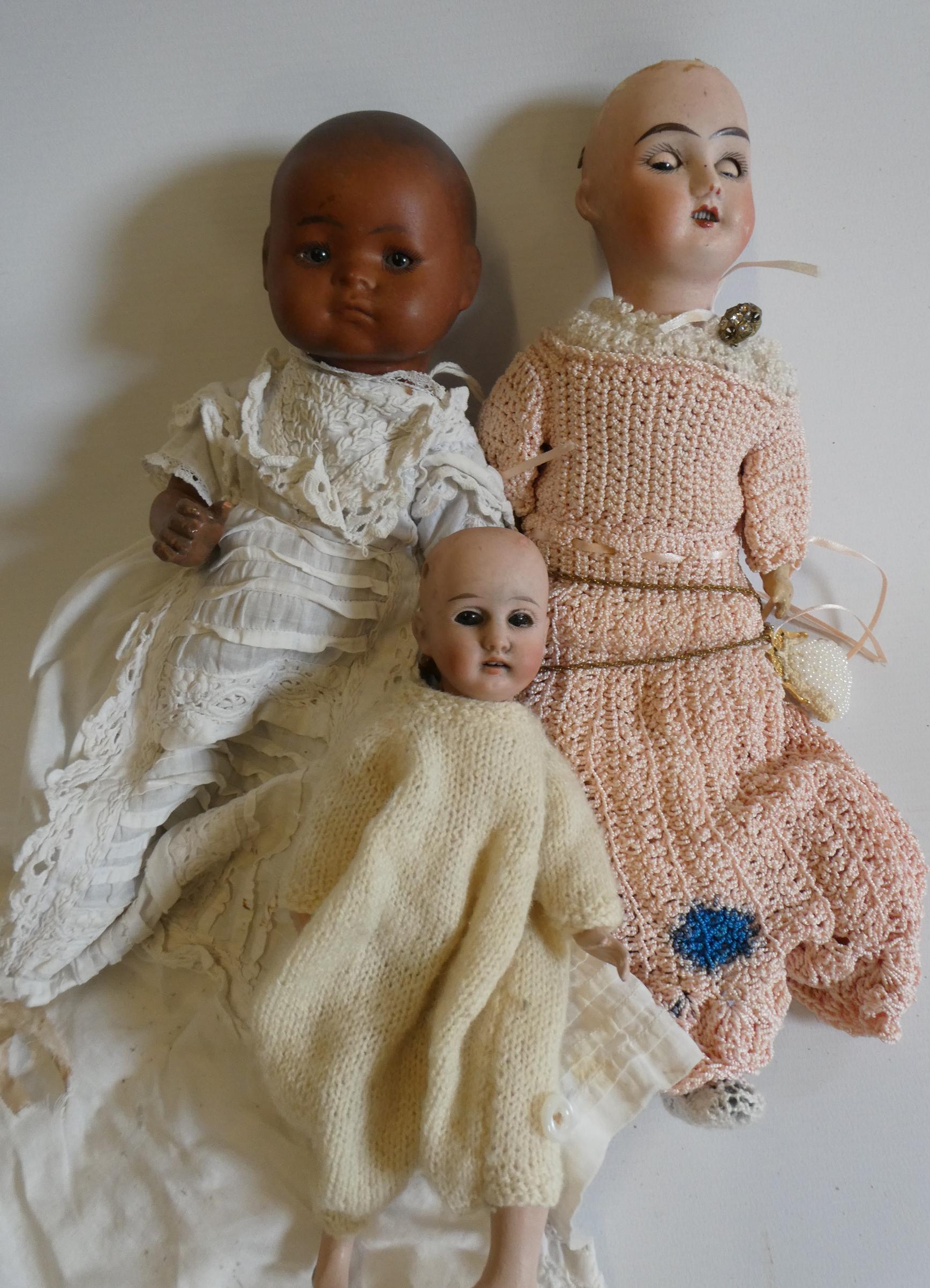 Three small bisque socket head dolls Image
