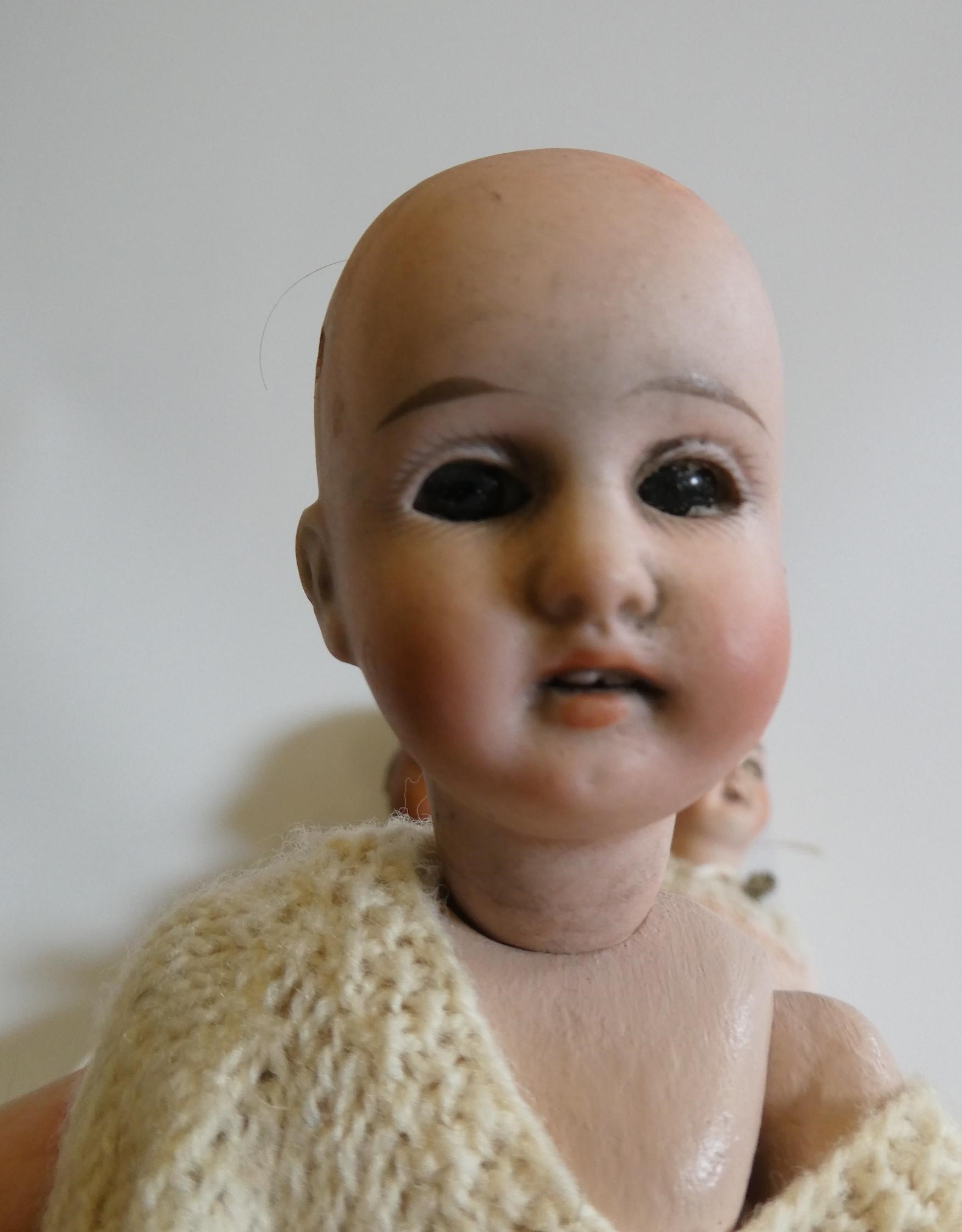 Three small bisque socket head dolls Image