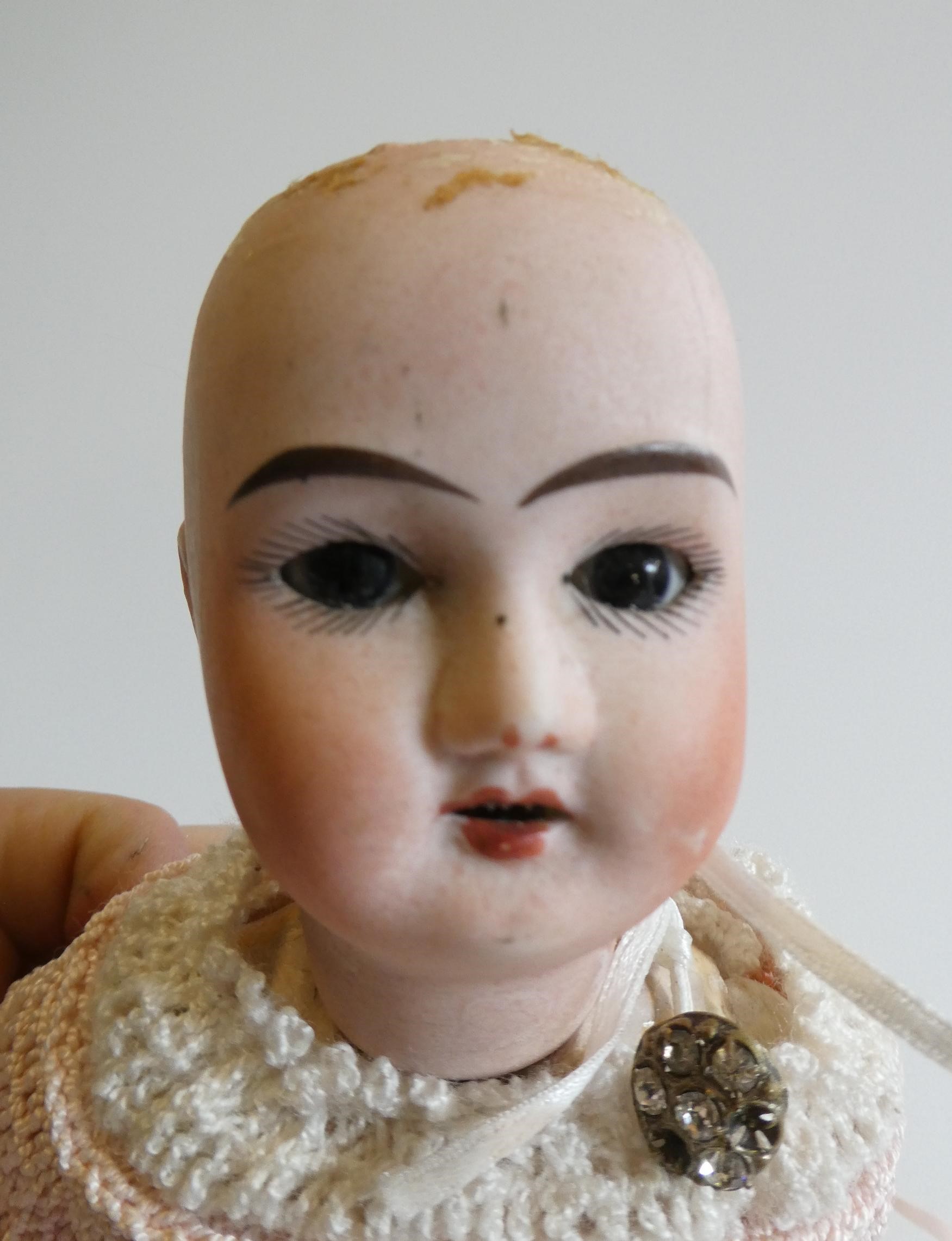 Three small bisque socket head dolls Image