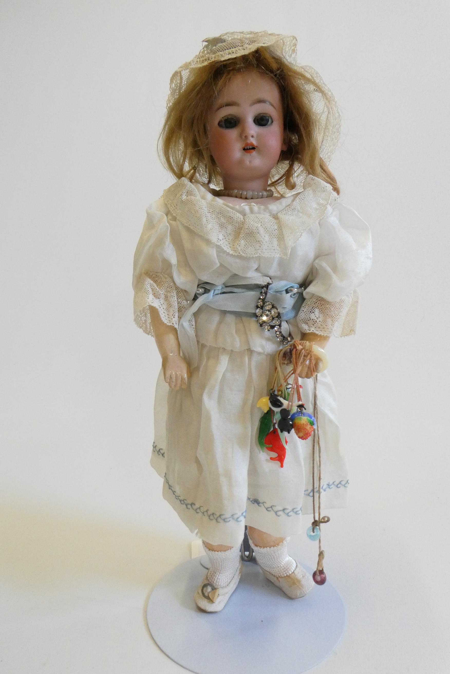 A Simon & Halbig socket head doll with blue glass sleeping eyes Image
