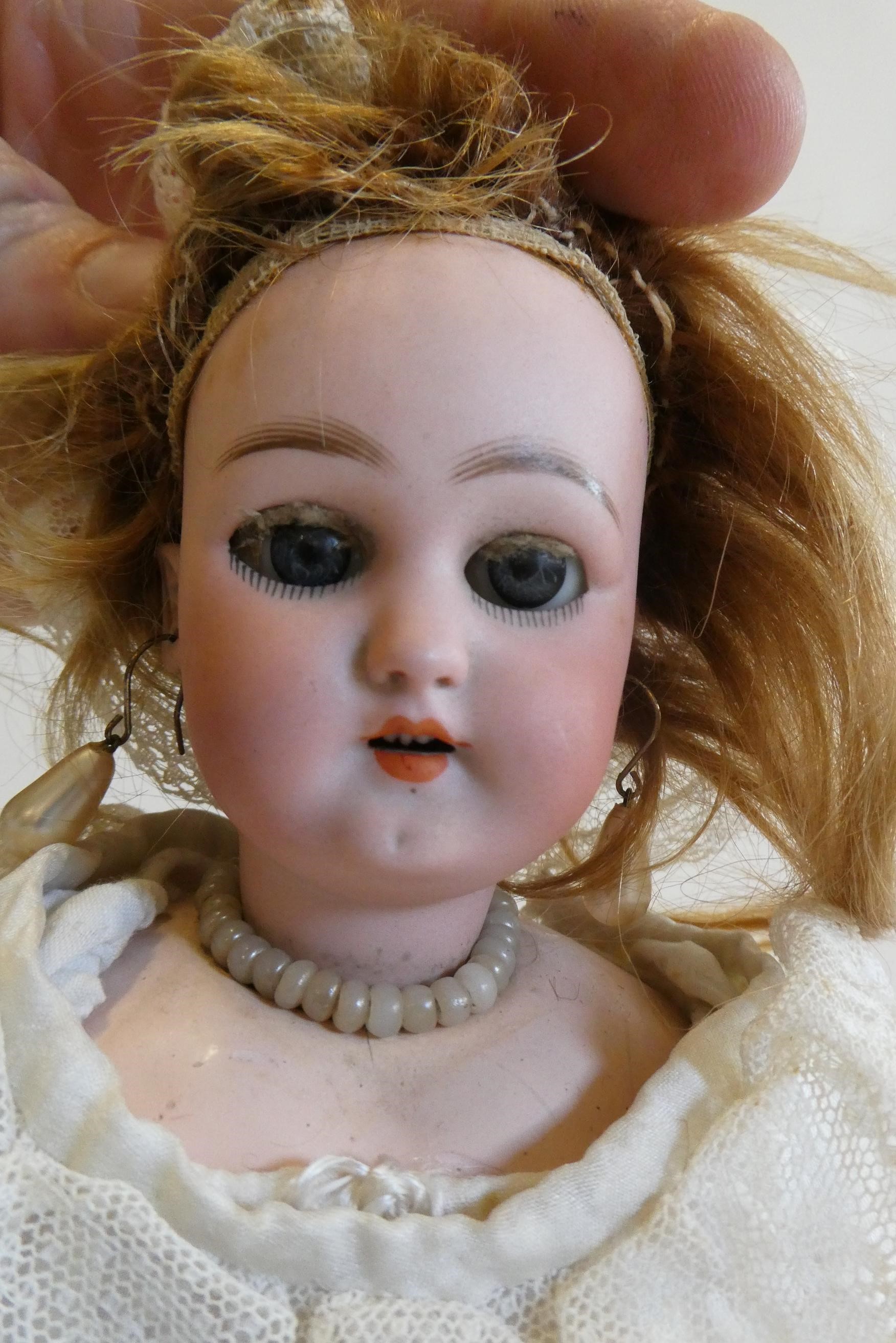 A Simon & Halbig socket head doll with blue glass sleeping eyes Image