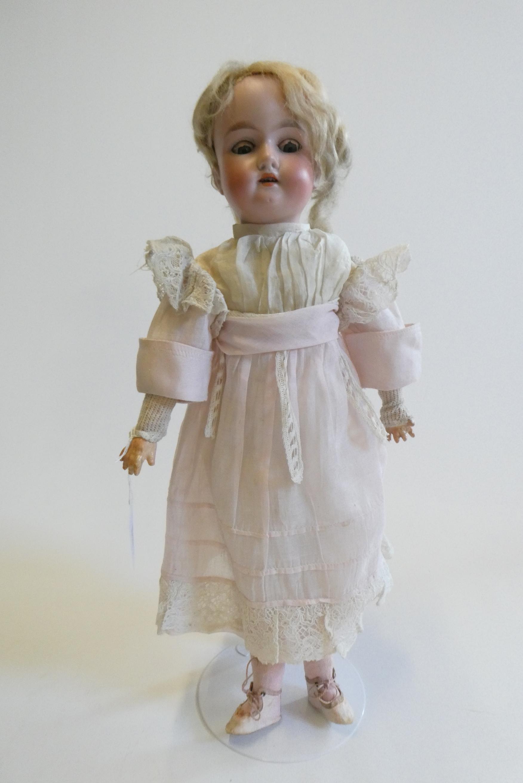 An Armand Marseille bisque socket head doll with blue glass sleeping eyes Image