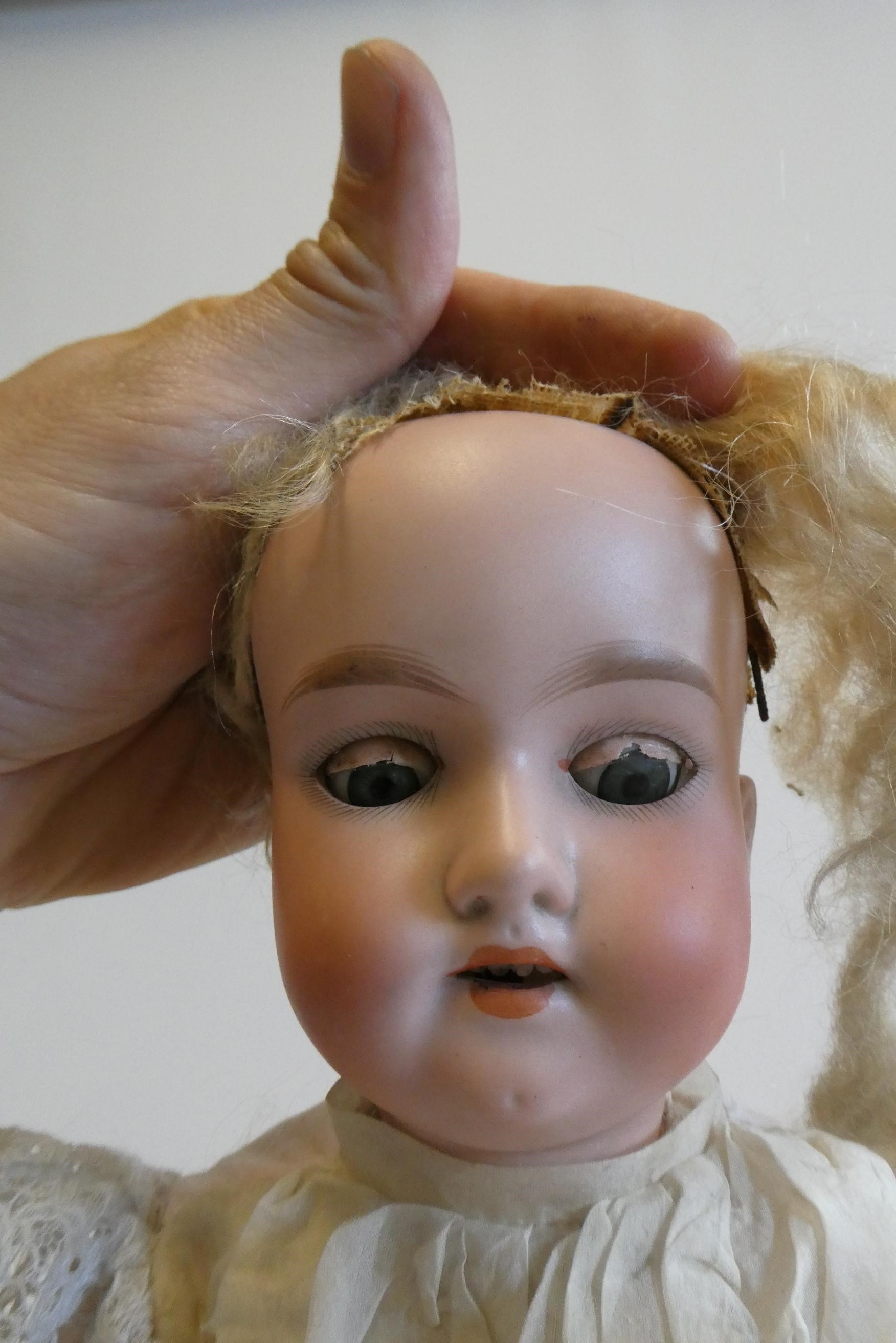 An Armand Marseille bisque socket head doll with blue glass sleeping eyes Image