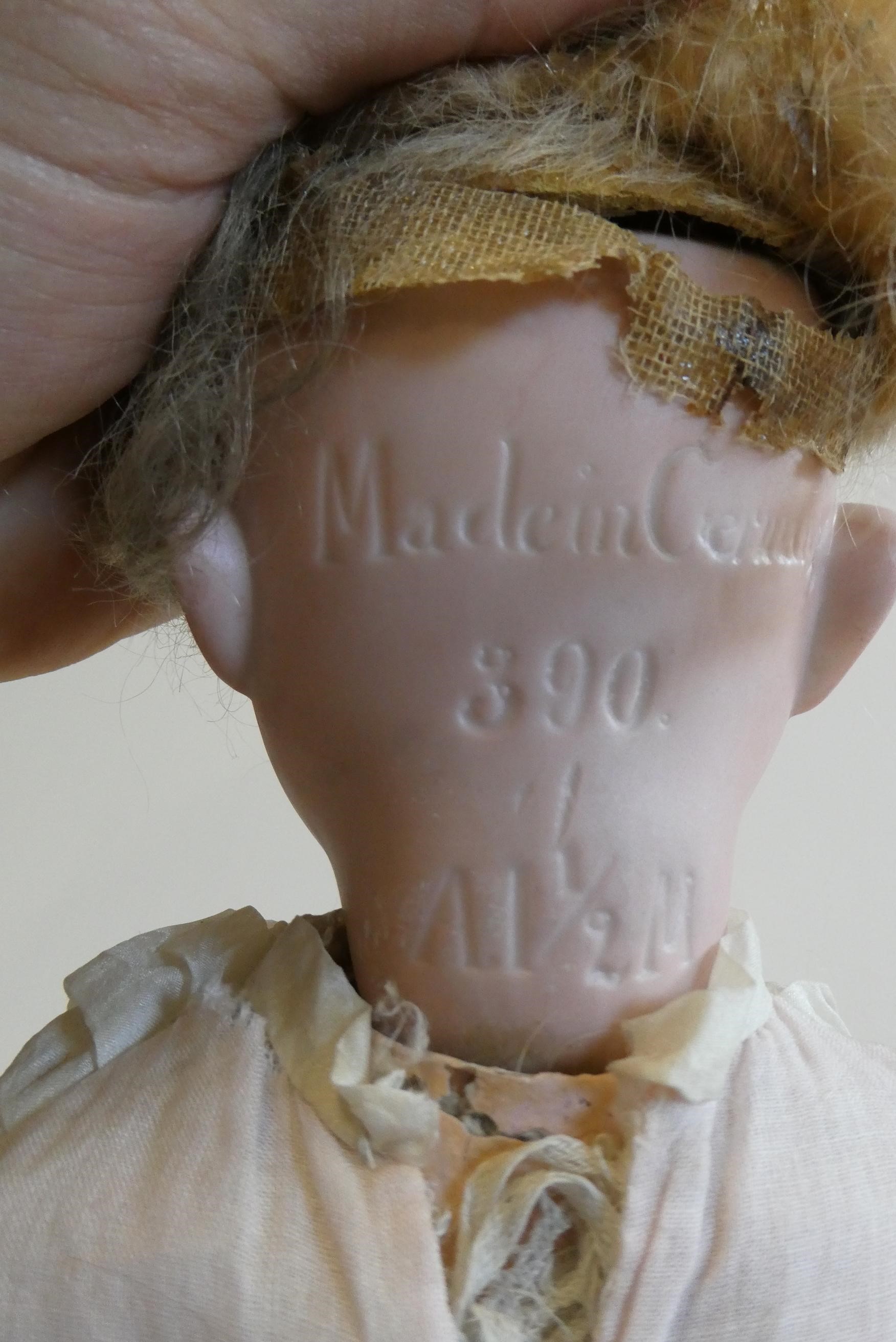 An Armand Marseille bisque socket head doll with blue glass sleeping eyes Image