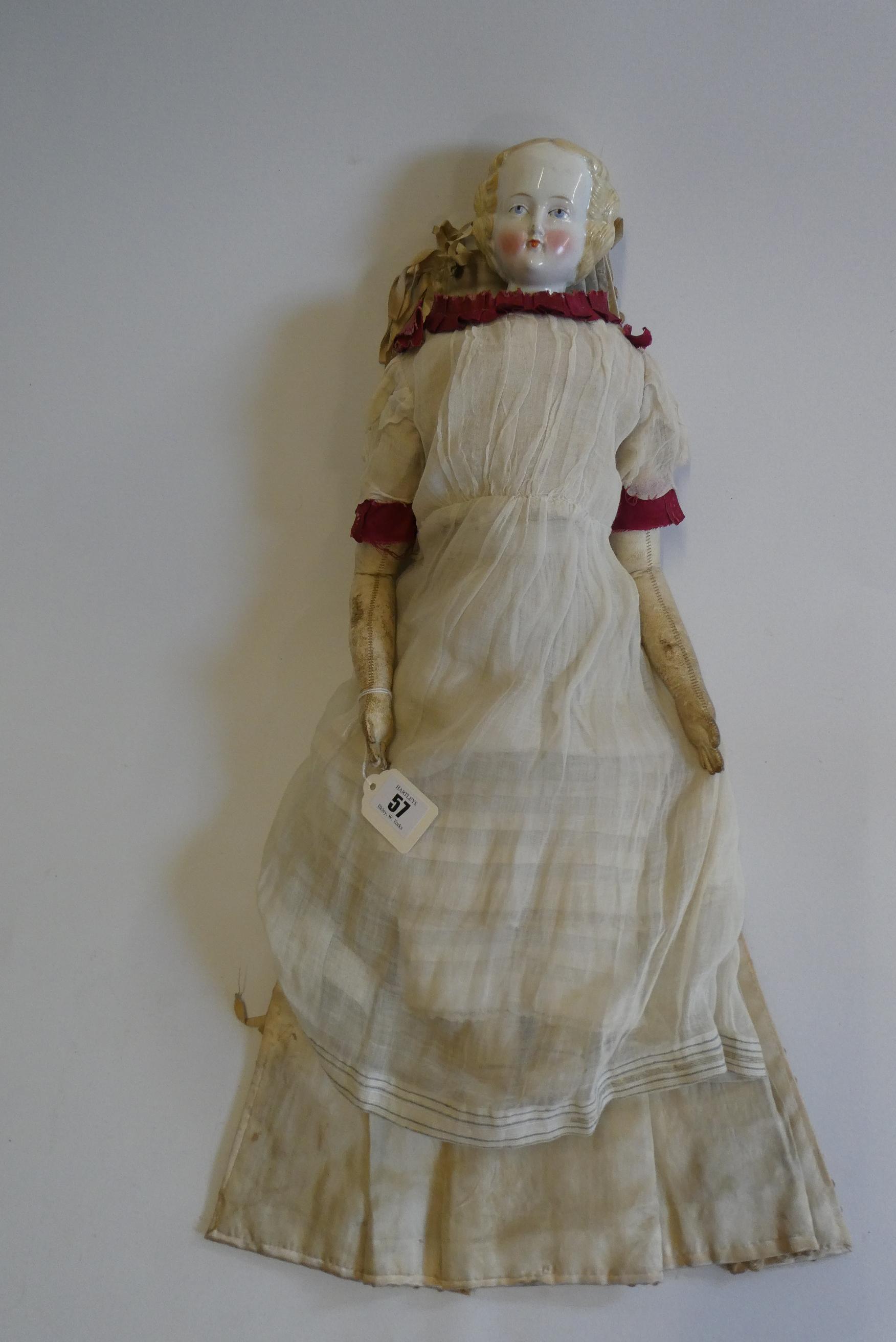 A Victorian china shoulder head doll with painted features, moulded hair, jointed kid body, lace Image