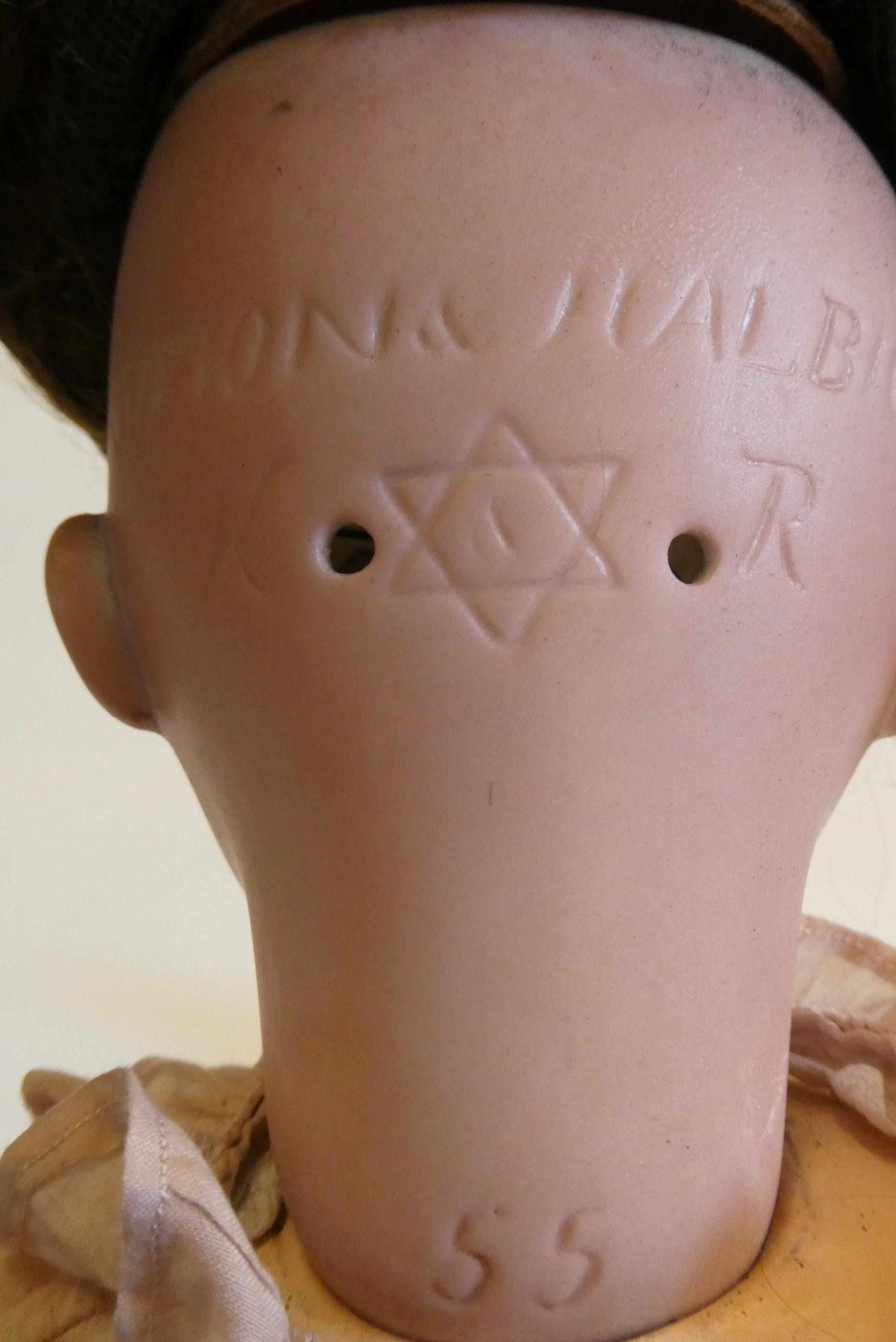 A Simon & Halbig Kammer & Reinhardt bisque socket head doll with brown glass sideways glancing Image