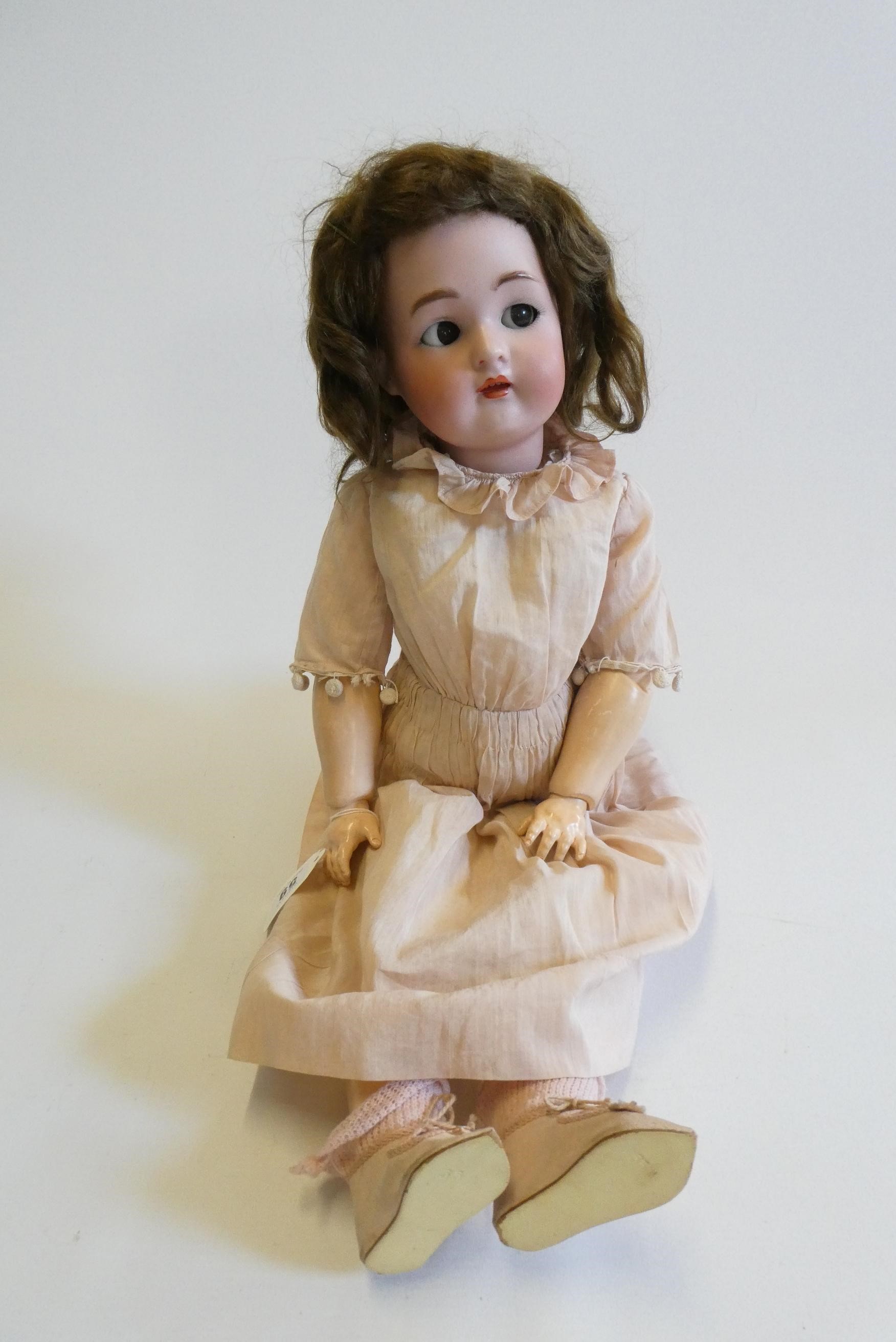 A Simon & Halbig Kammer & Reinhardt bisque socket head doll with brown glass sideways glancing Image