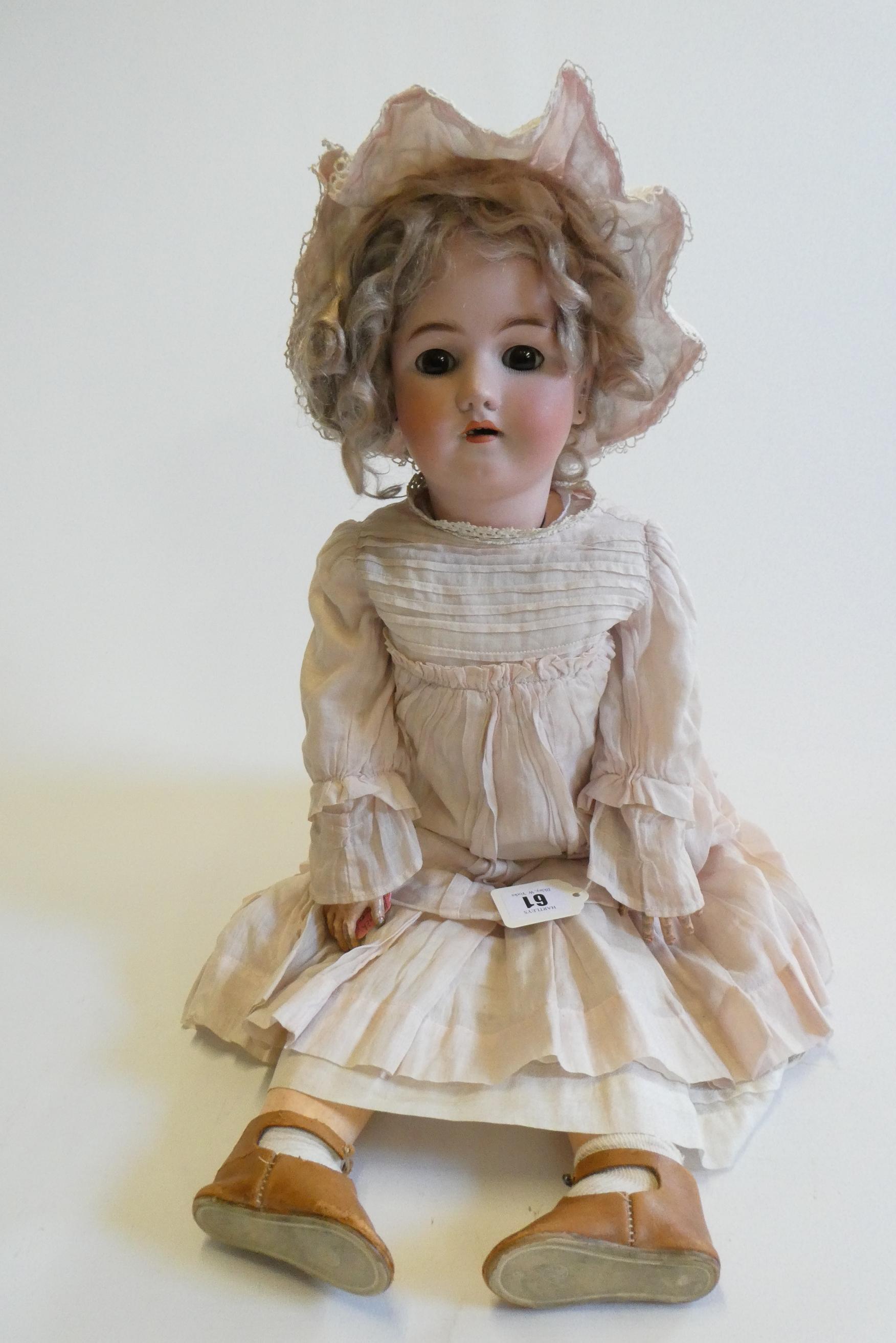 A Heinrich Handwerck Simon & Halbig bisque socket head doll with brown glass sleeping eyes Image