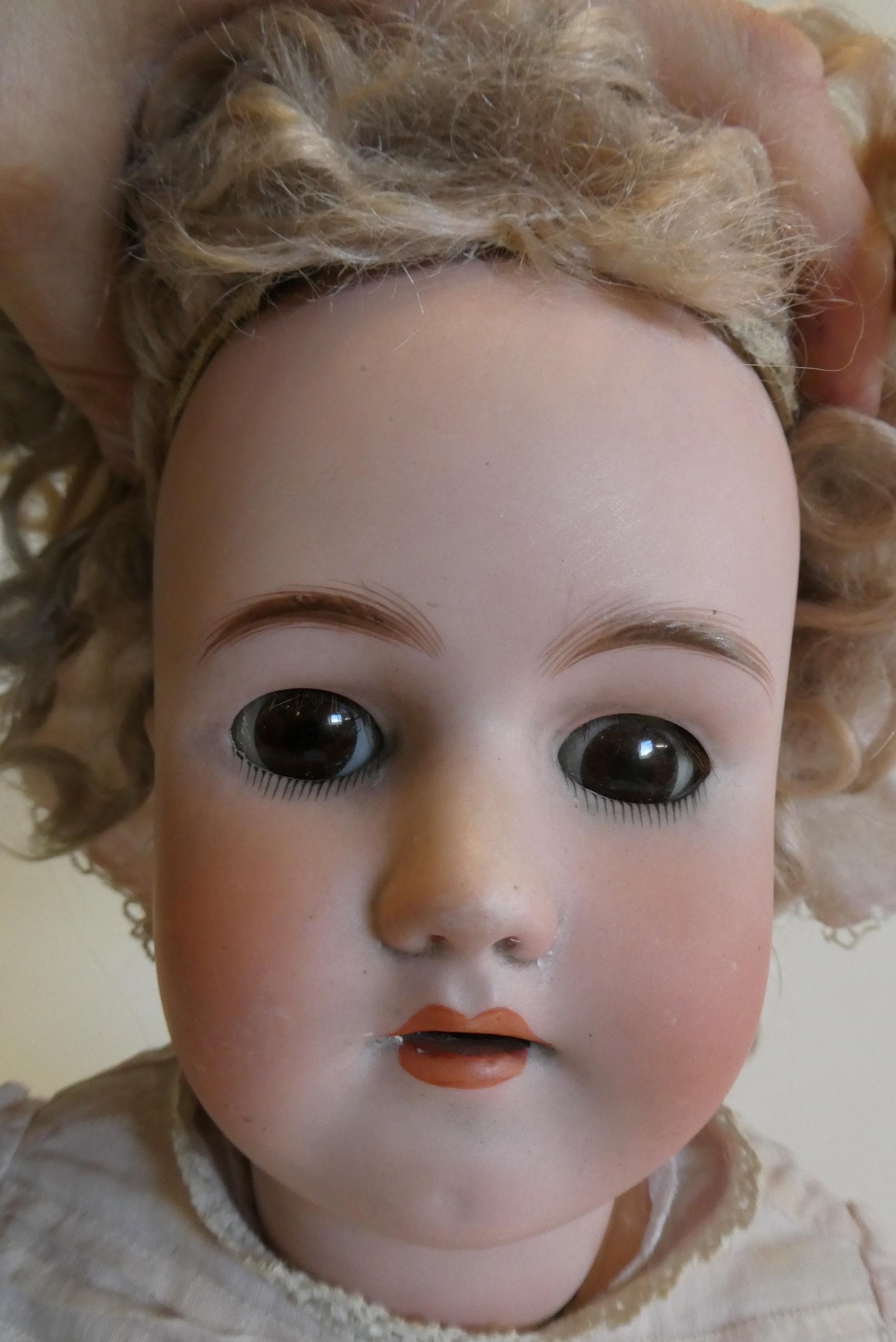 A Heinrich Handwerck Simon & Halbig bisque socket head doll with brown glass sleeping eyes Image