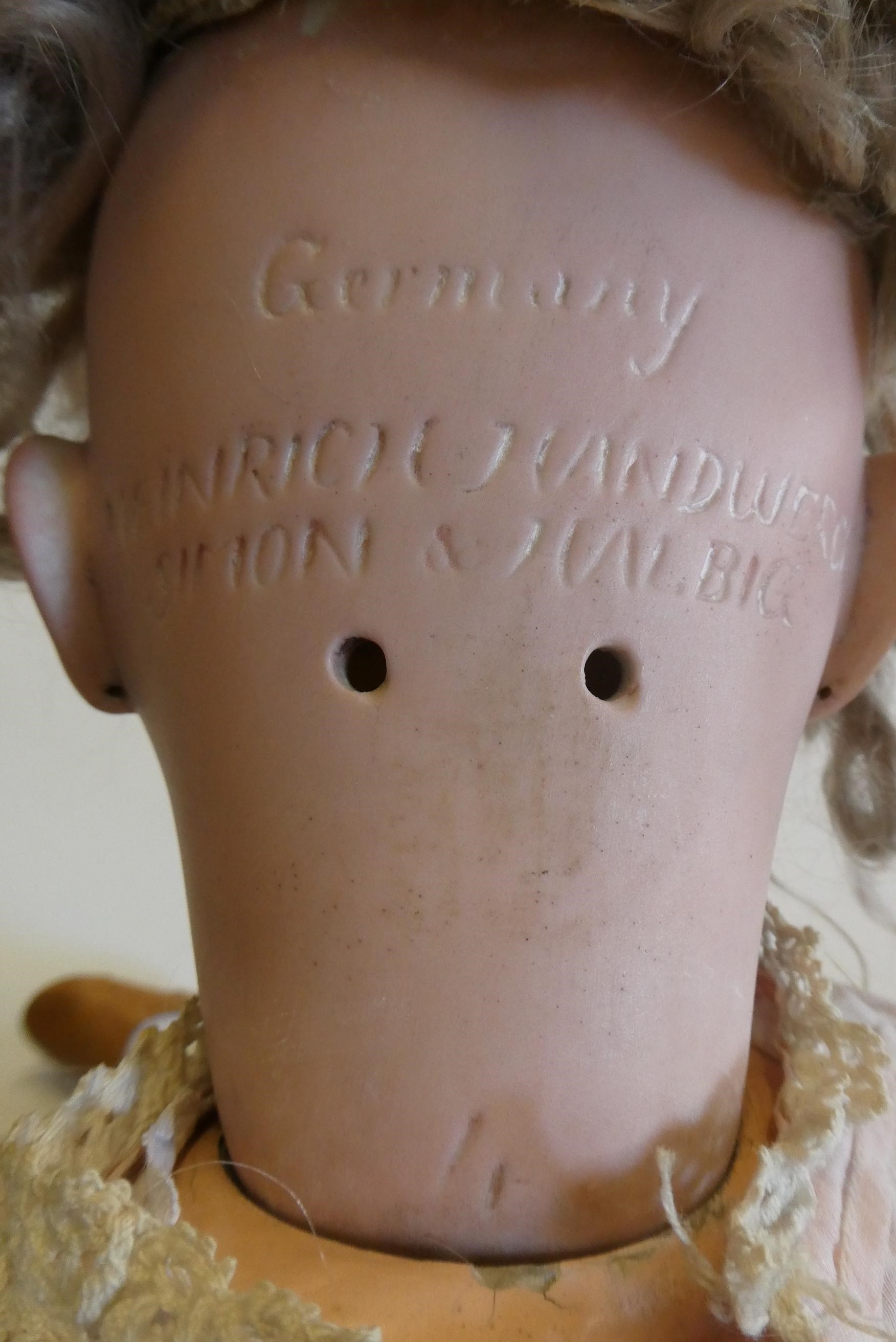 A Heinrich Handwerck Simon & Halbig bisque socket head doll with brown glass sleeping eyes Image