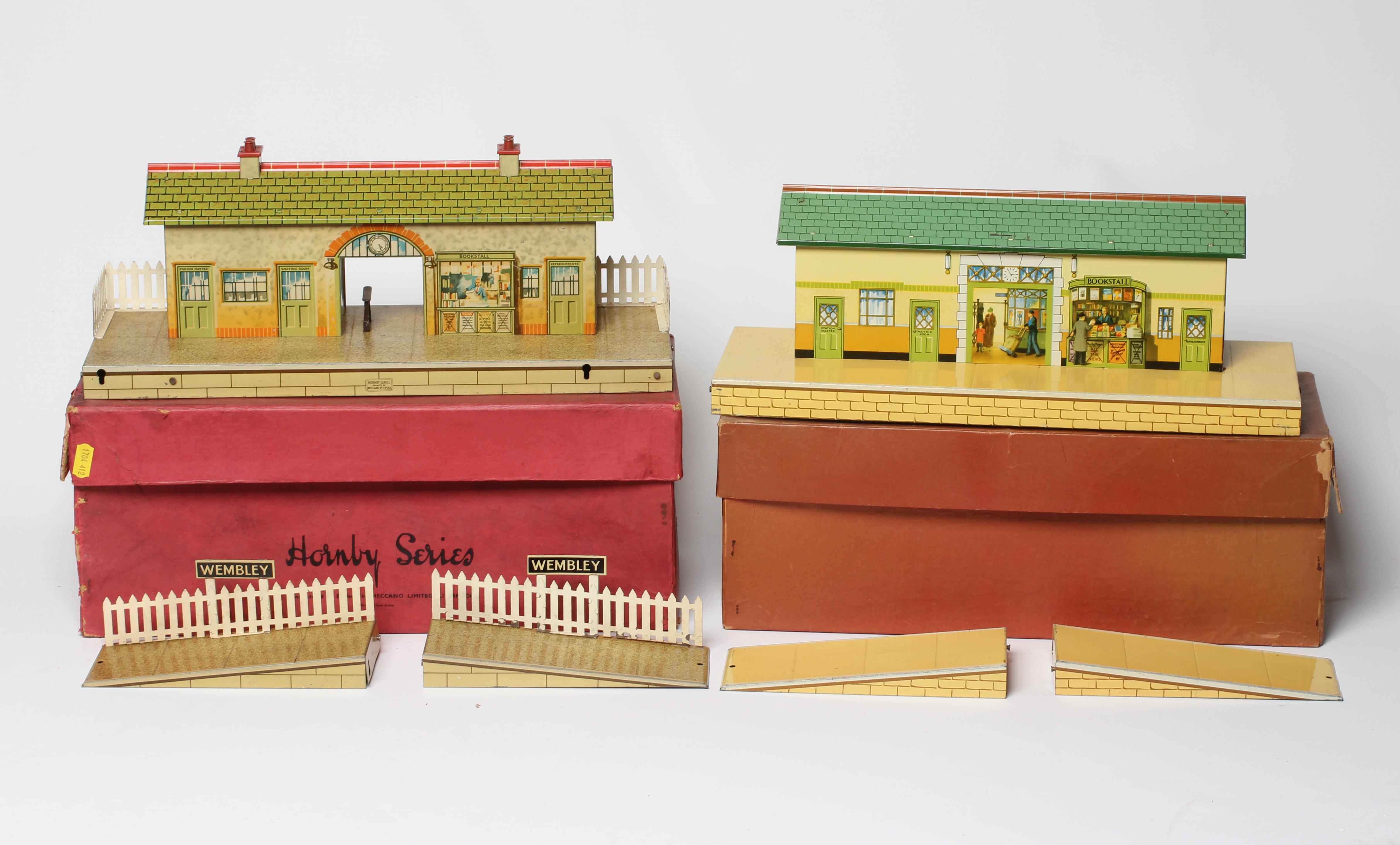 Hornby O gauge station, No 4 with signs for Wembley, together with a No 3, both boxed, items good, Image