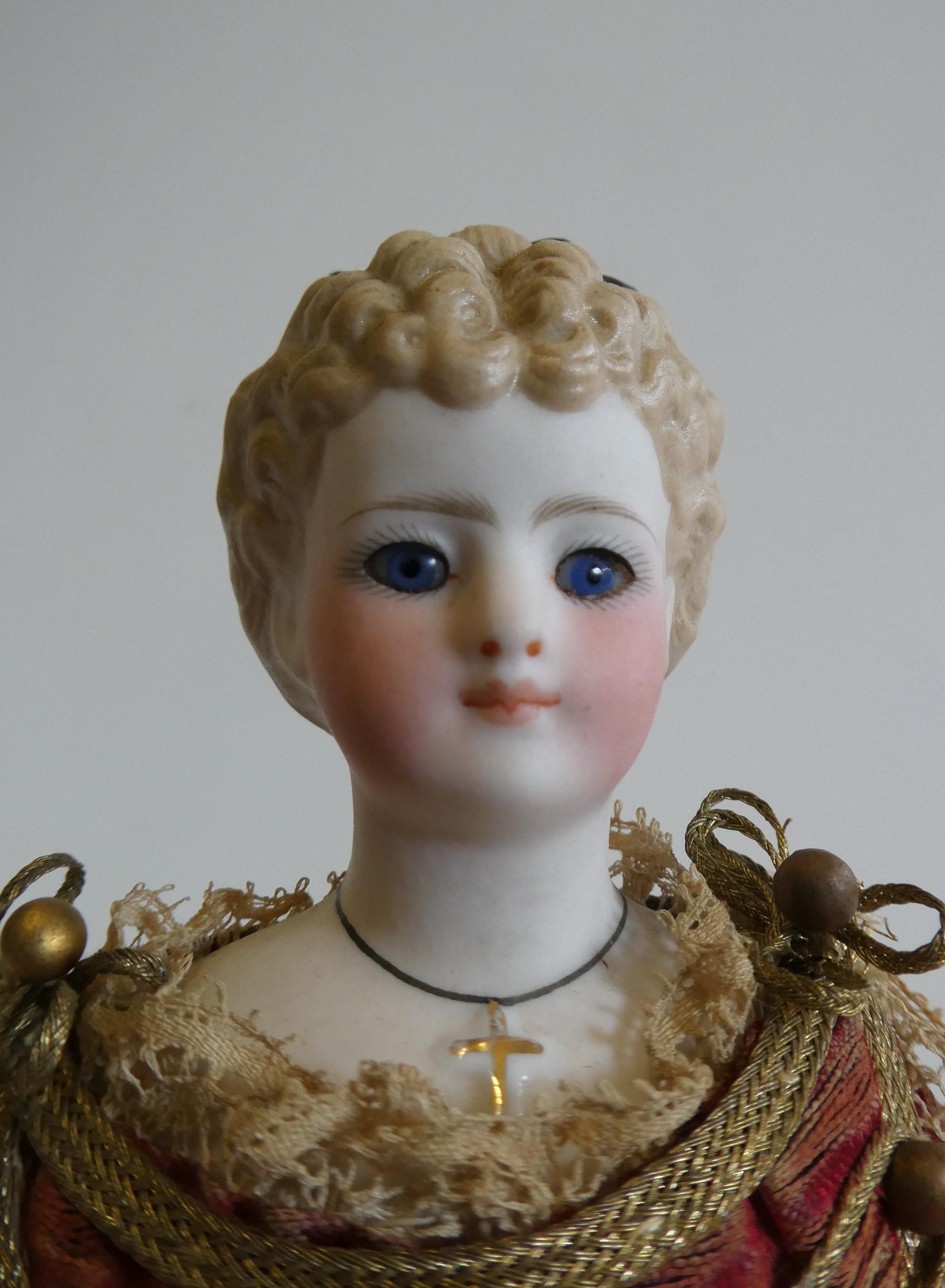 A rare late Victorian bisque shoulder head fortune doll with blue glass fixed eyes Image