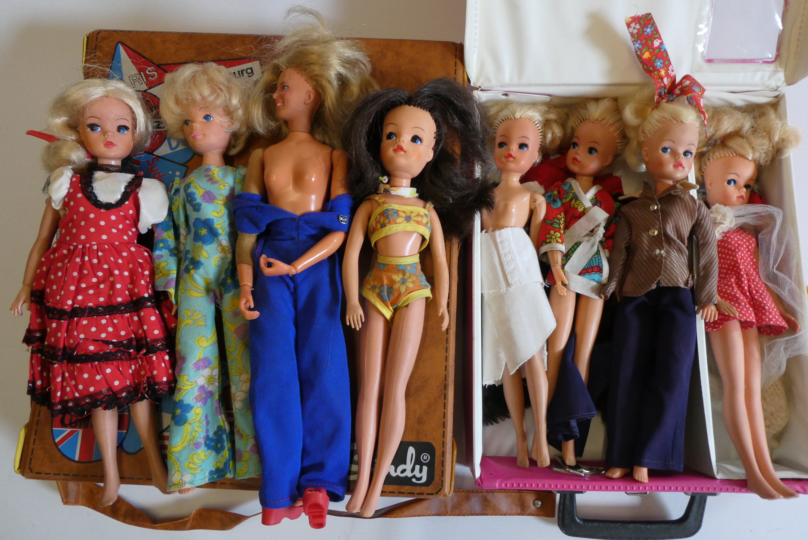 Seven Sindy dolls with two carrying cases and a quantity of clothing, together with another doll by Image