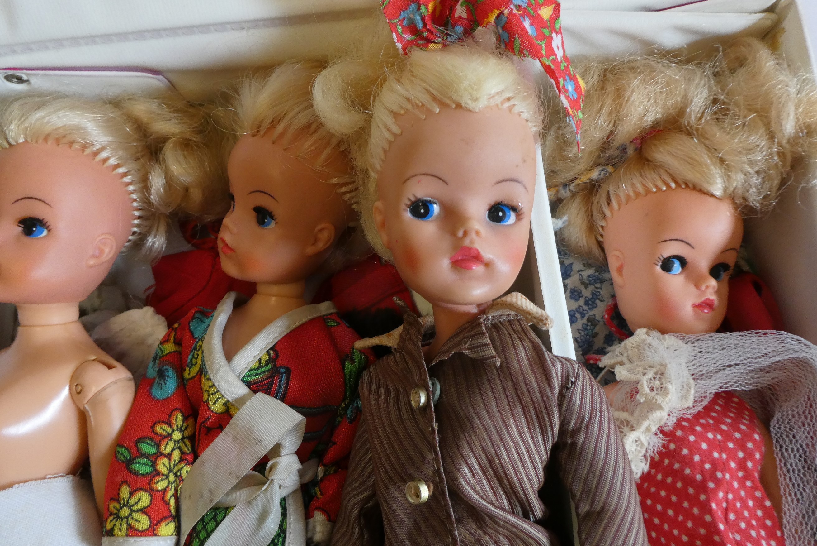 Seven Sindy dolls with two carrying cases and a quantity of clothing, together with another doll by Image