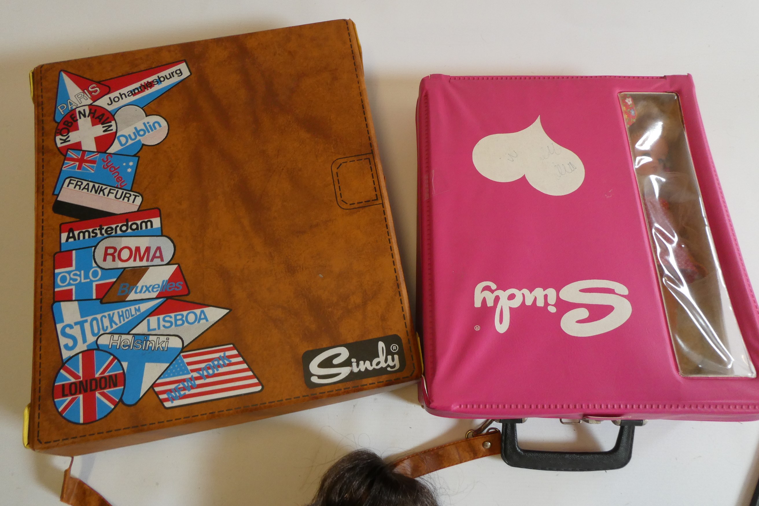 Seven Sindy dolls with two carrying cases and a quantity of clothing, together with another doll by Image