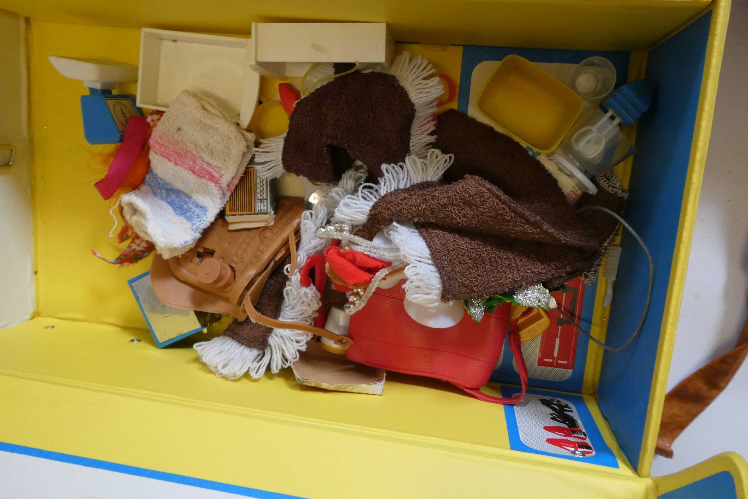 Seven Sindy dolls with two carrying cases and a quantity of clothing, together with another doll by Image