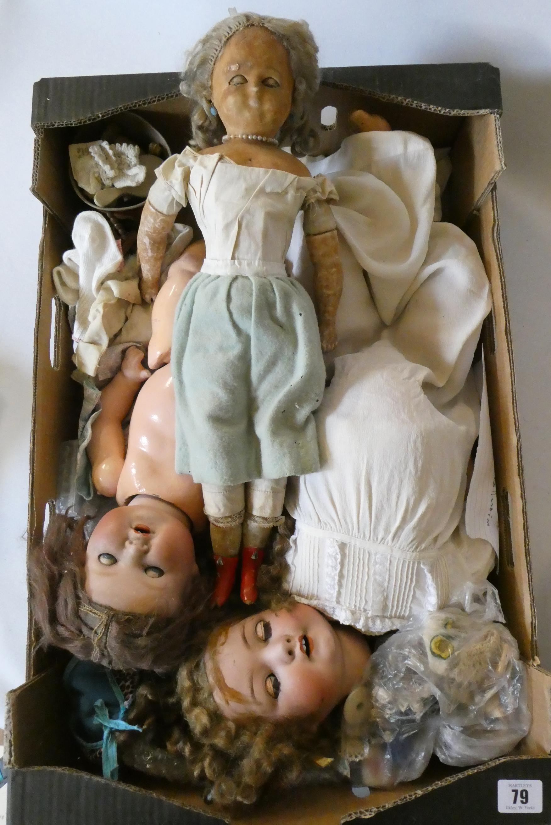 A box of dolls, parts, clothes, hats and accessories including an antique wax doll, Image