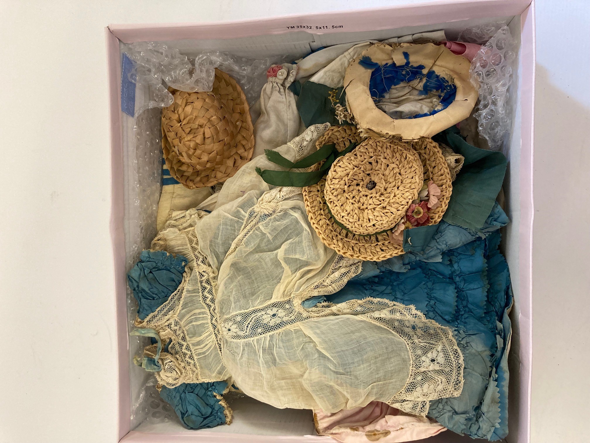 A box of dolls, parts, clothes, hats and accessories including an antique wax doll, Image