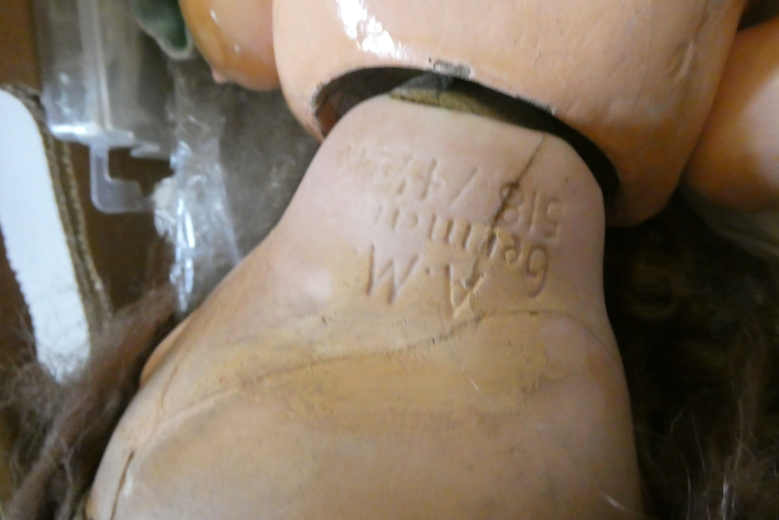 A box of dolls, parts, clothes, hats and accessories including an antique wax doll, Image