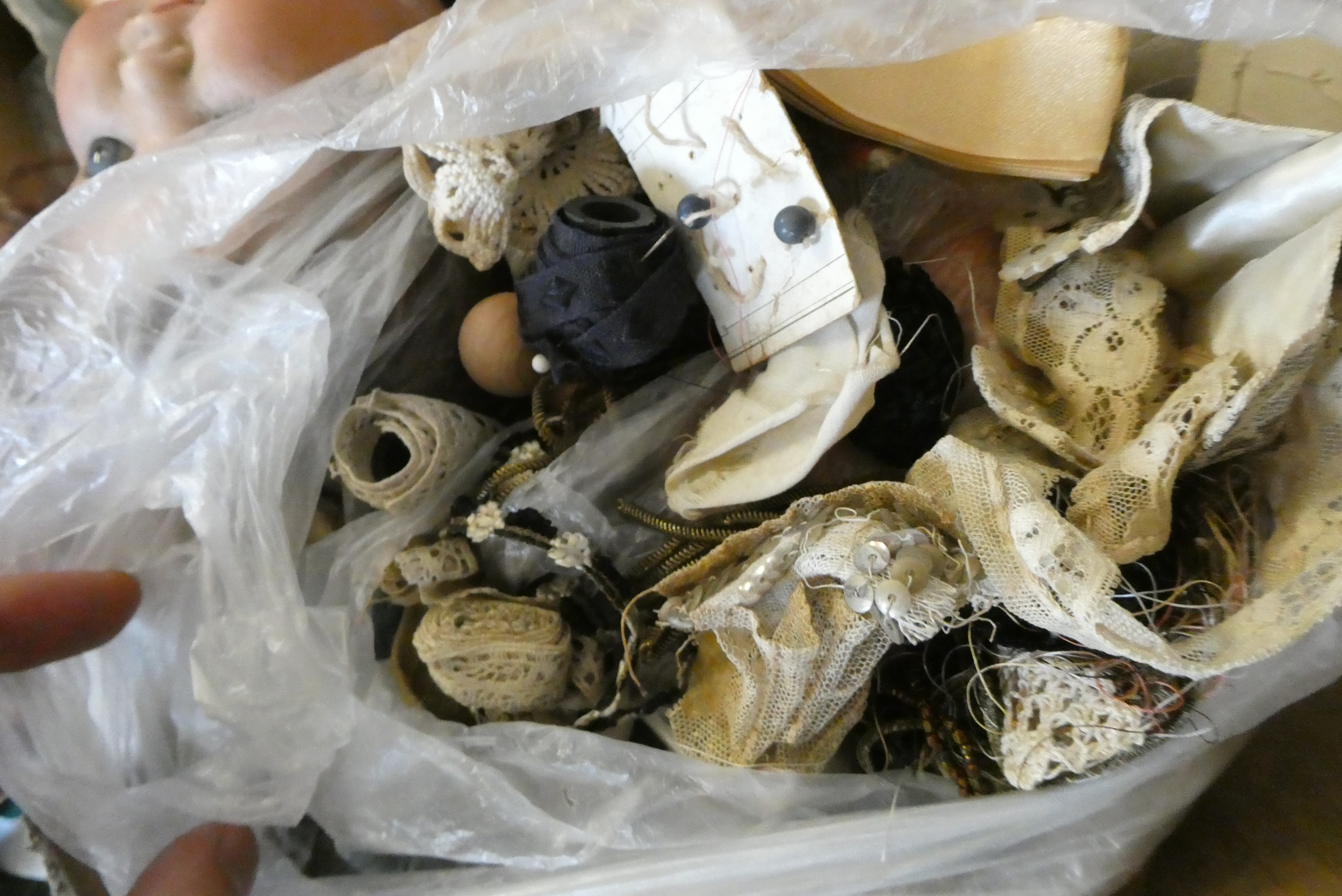 A box of dolls, parts, clothes, hats and accessories including an antique wax doll, Image