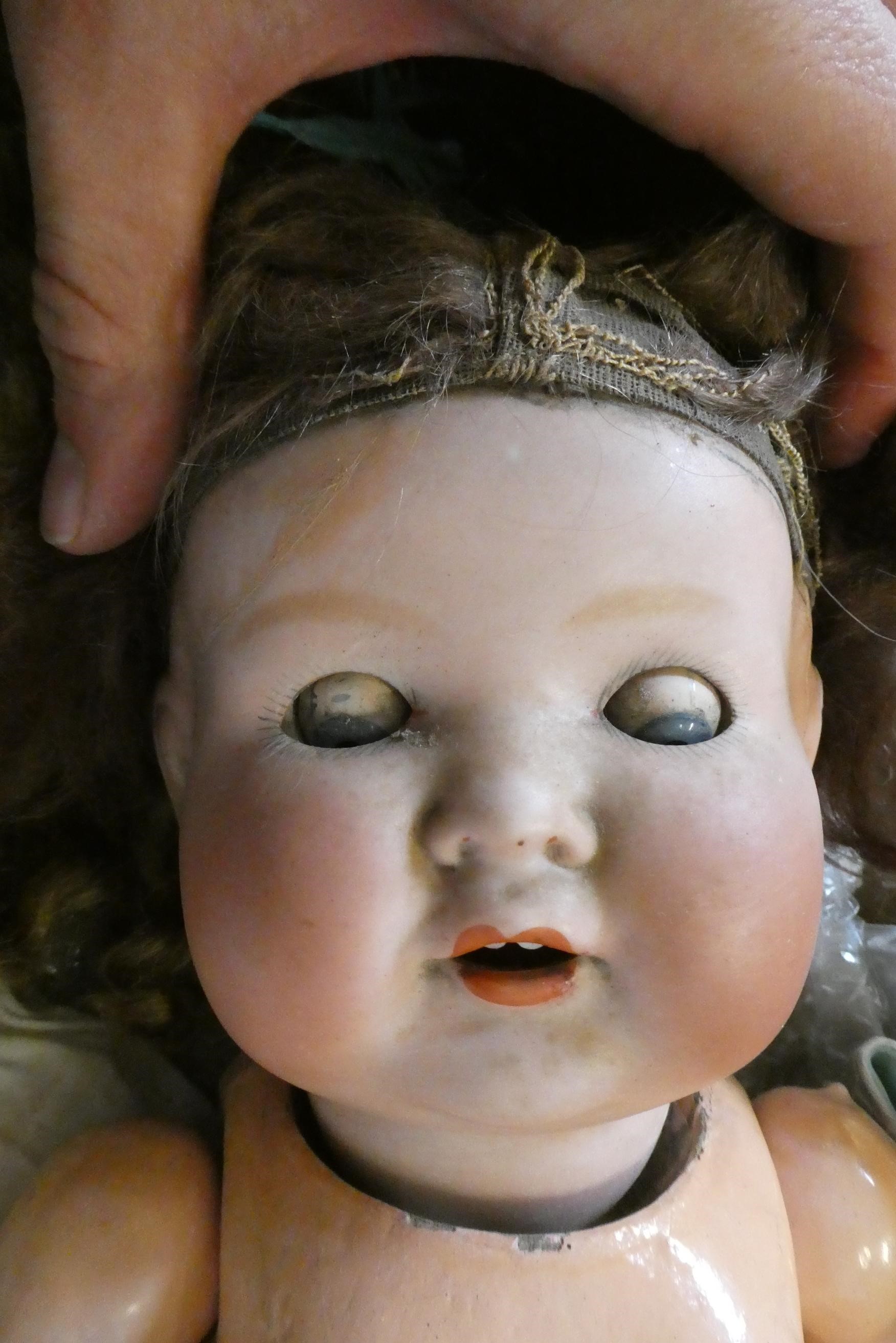 A box of dolls, parts, clothes, hats and accessories including an antique wax doll, Image