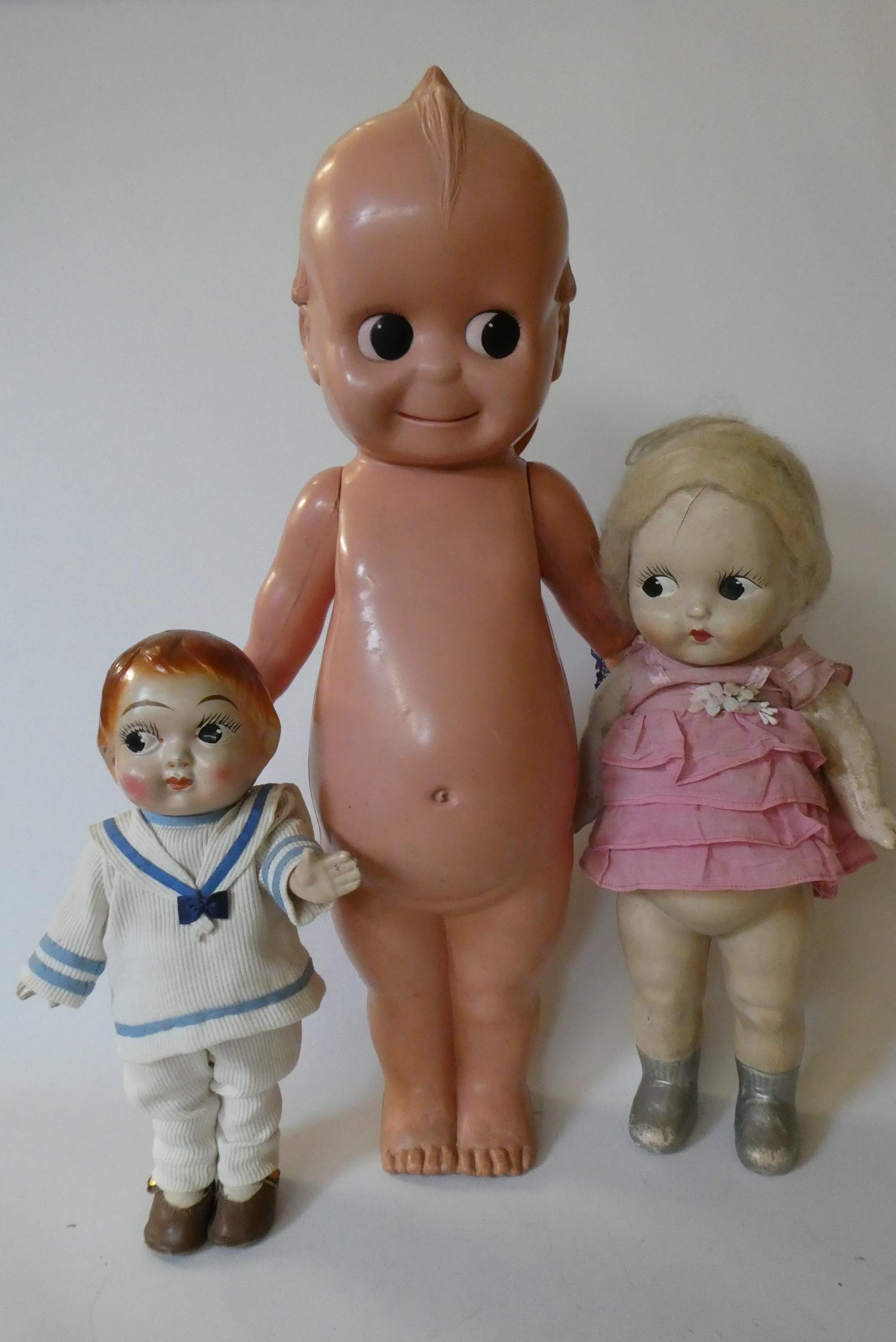 Three large Kewpie type dolls, one 26" celluloid doll, a 17 1/2" composition girl and a 13 1/2" Image