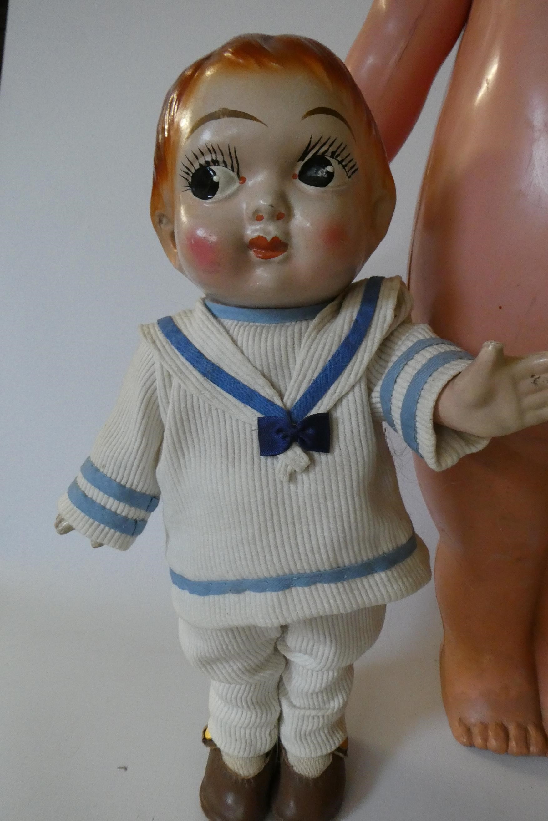 Three large Kewpie type dolls, one 26" celluloid doll, a 17 1/2" composition girl and a 13 1/2" Image