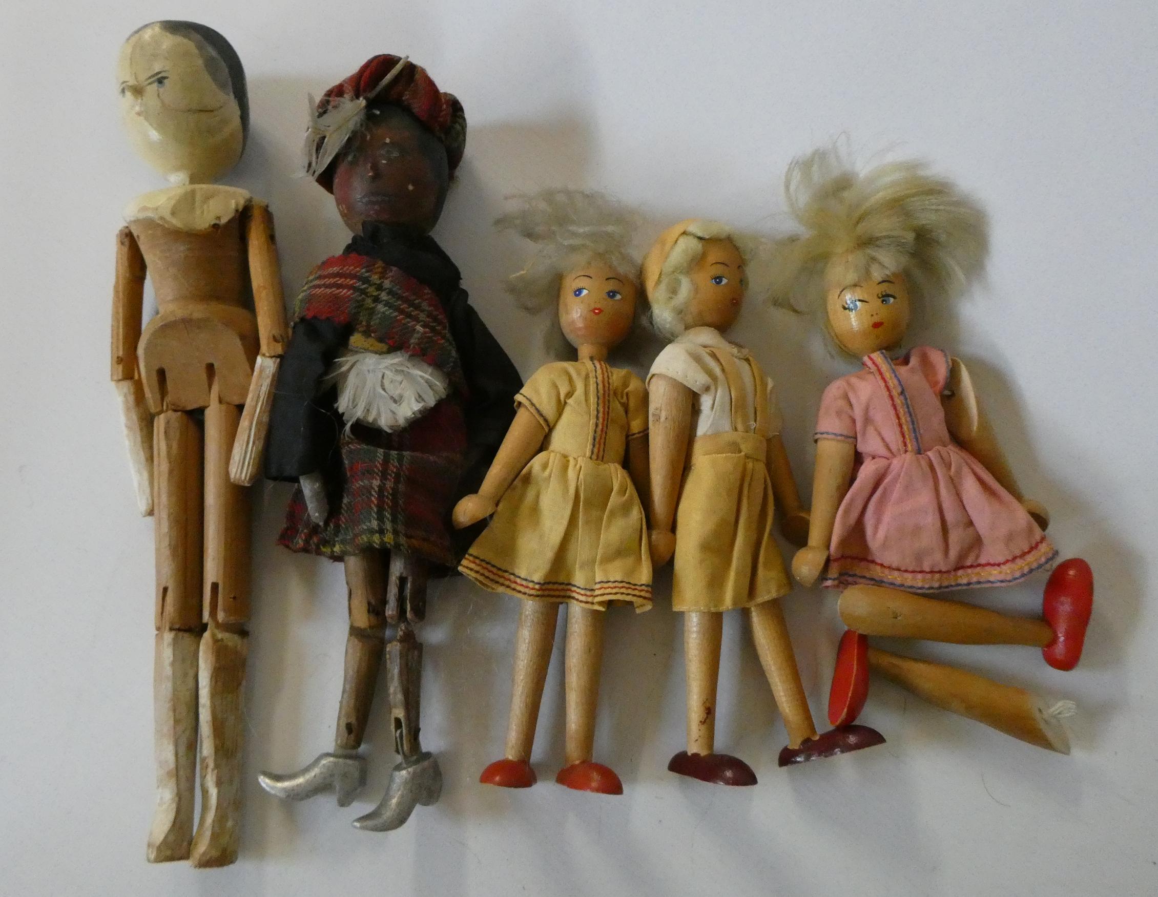 Five wooden peg dolls, comprising one 11 3/4" Victorian example, a 10" Scottish doll with metal Image