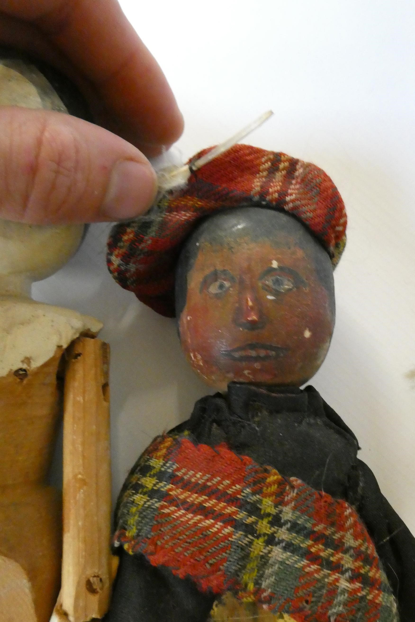 Five wooden peg dolls, comprising one 11 3/4" Victorian example, a 10" Scottish doll with metal Image