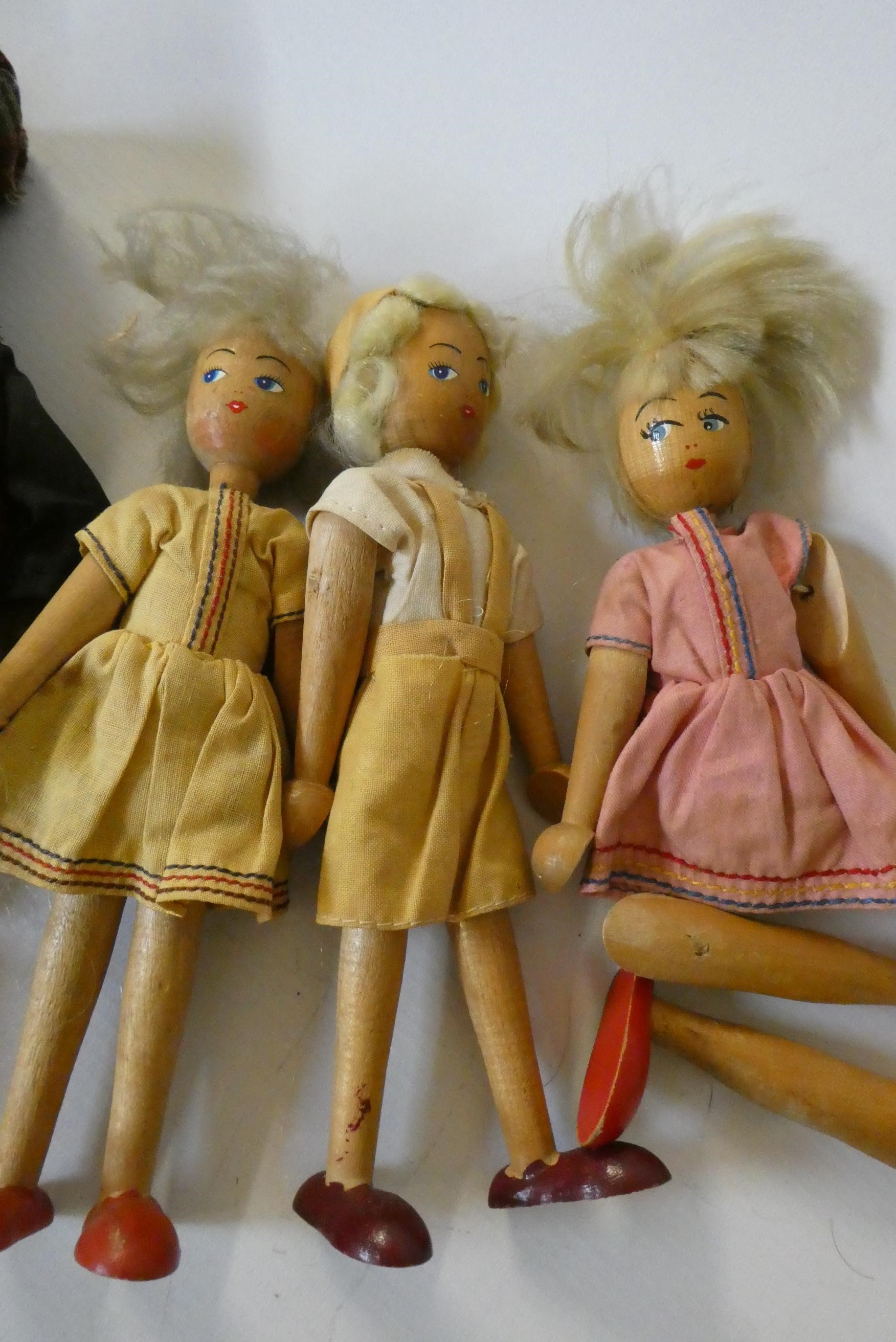 Five wooden peg dolls, comprising one 11 3/4" Victorian example, a 10" Scottish doll with metal Image