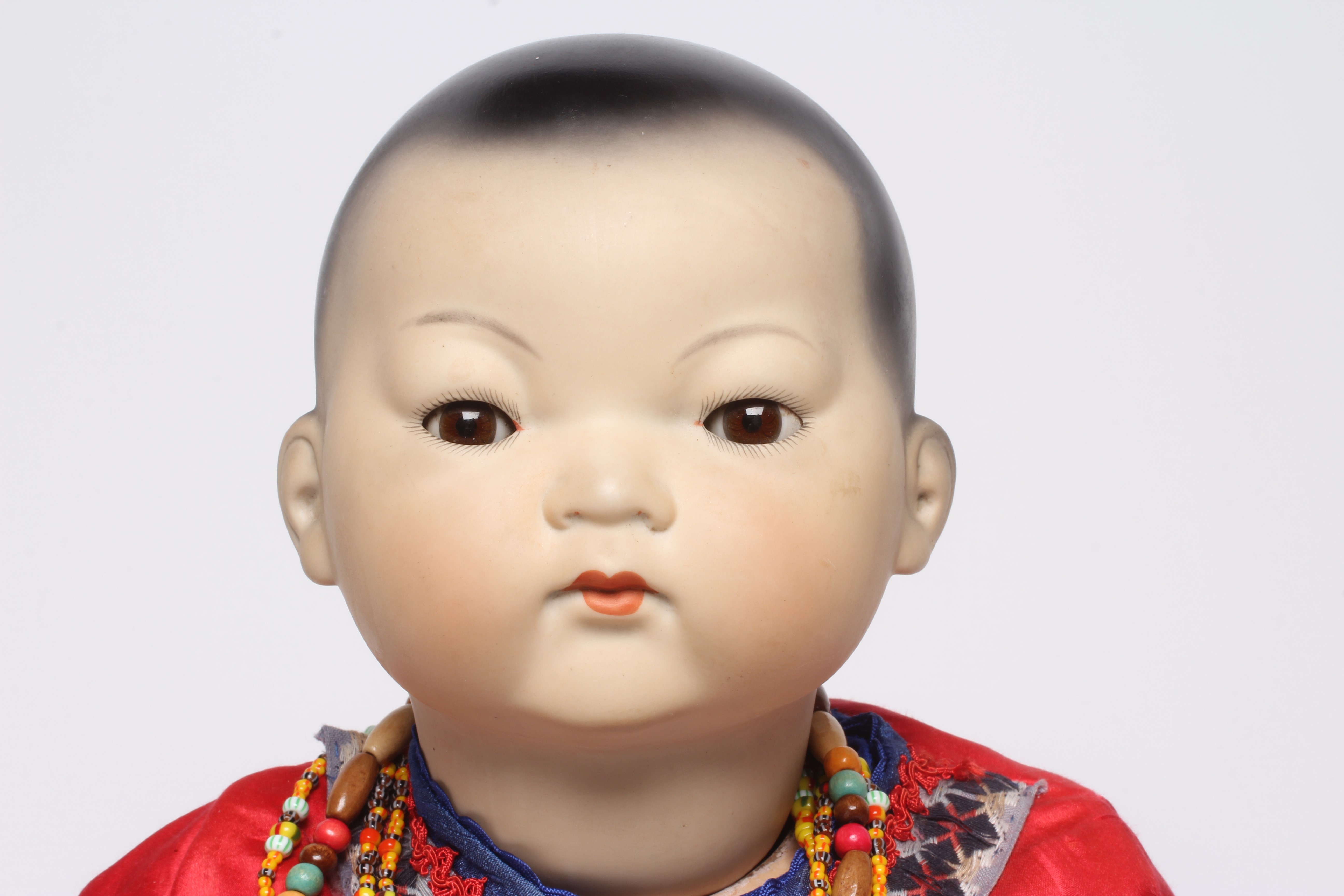 An Armand Marseille bisque socket head Asian doll Image