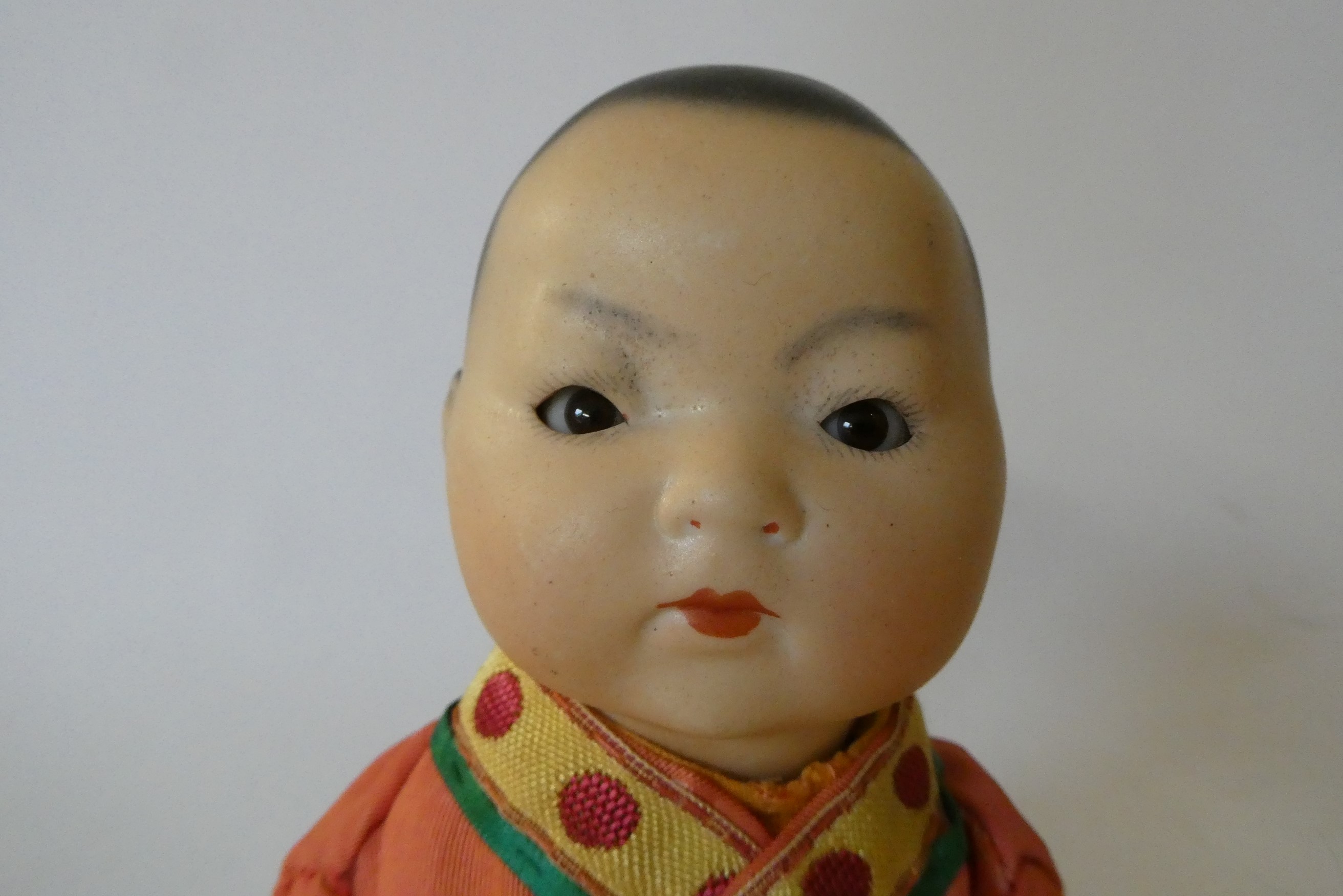 An Armand Marseille bisque socket head Asian doll Image