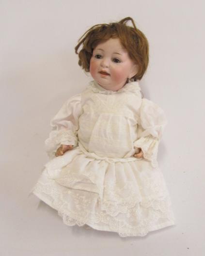 A Kestner bisque head character doll with brown glass sleeping eyes Image