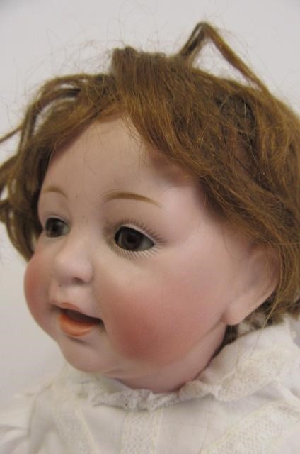 A Kestner bisque head character doll with brown glass sleeping eyes Image