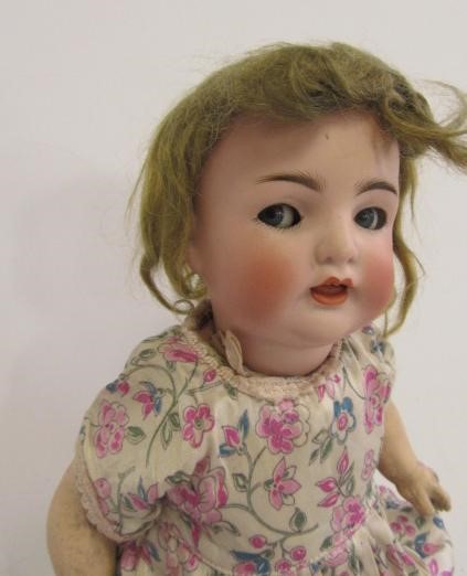 A Franz Schmidt bisque head character doll with blue glass flirty eyes Image