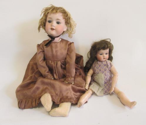 An Armand Marseille bisque head doll with blue glass sleeping eyes Image