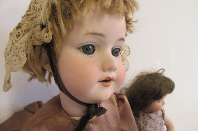 An Armand Marseille bisque head doll with blue glass sleeping eyes Image